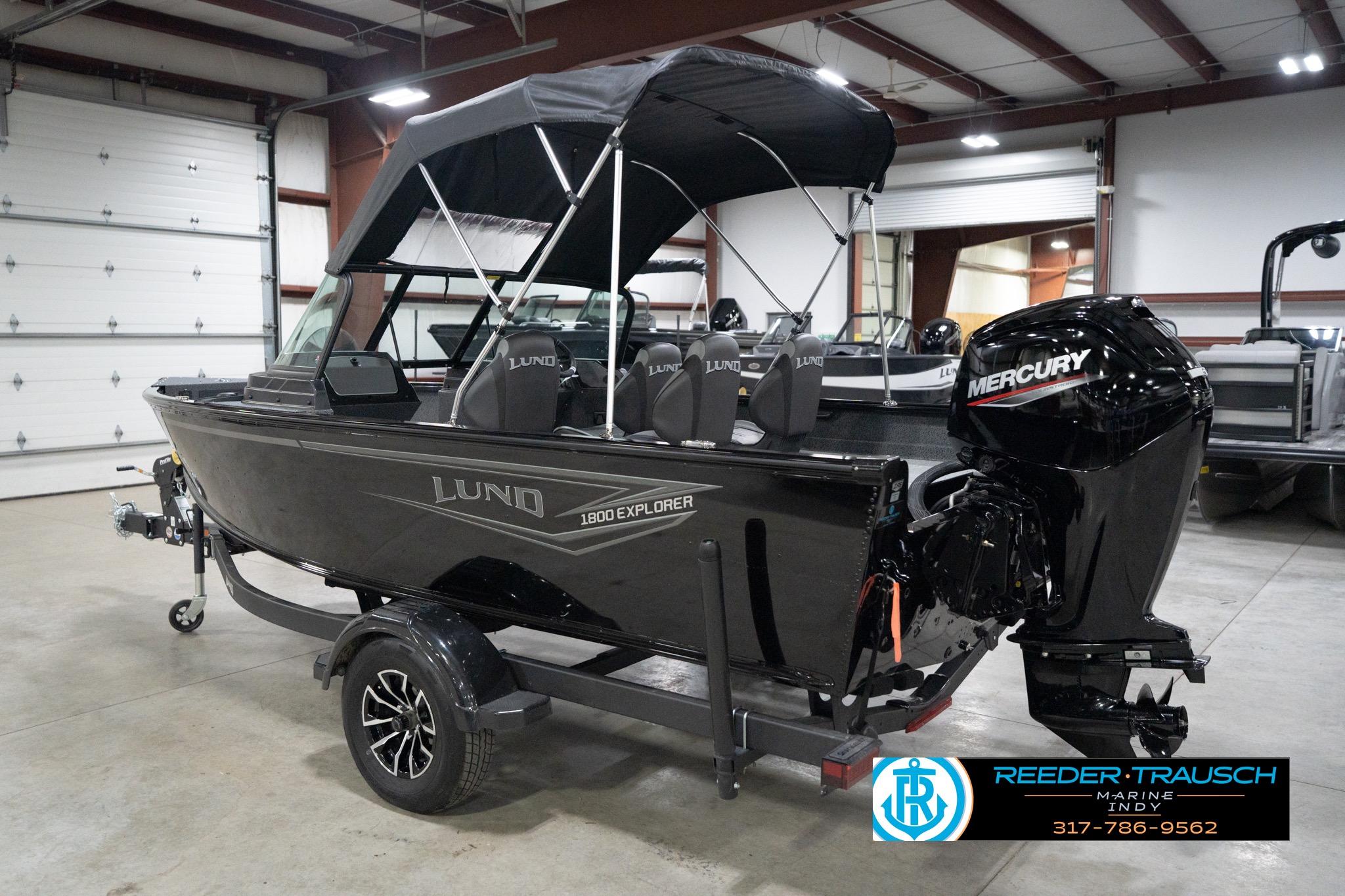 2026 Lund 1800 Explorer Sport boat with Mercury engine in showroom.