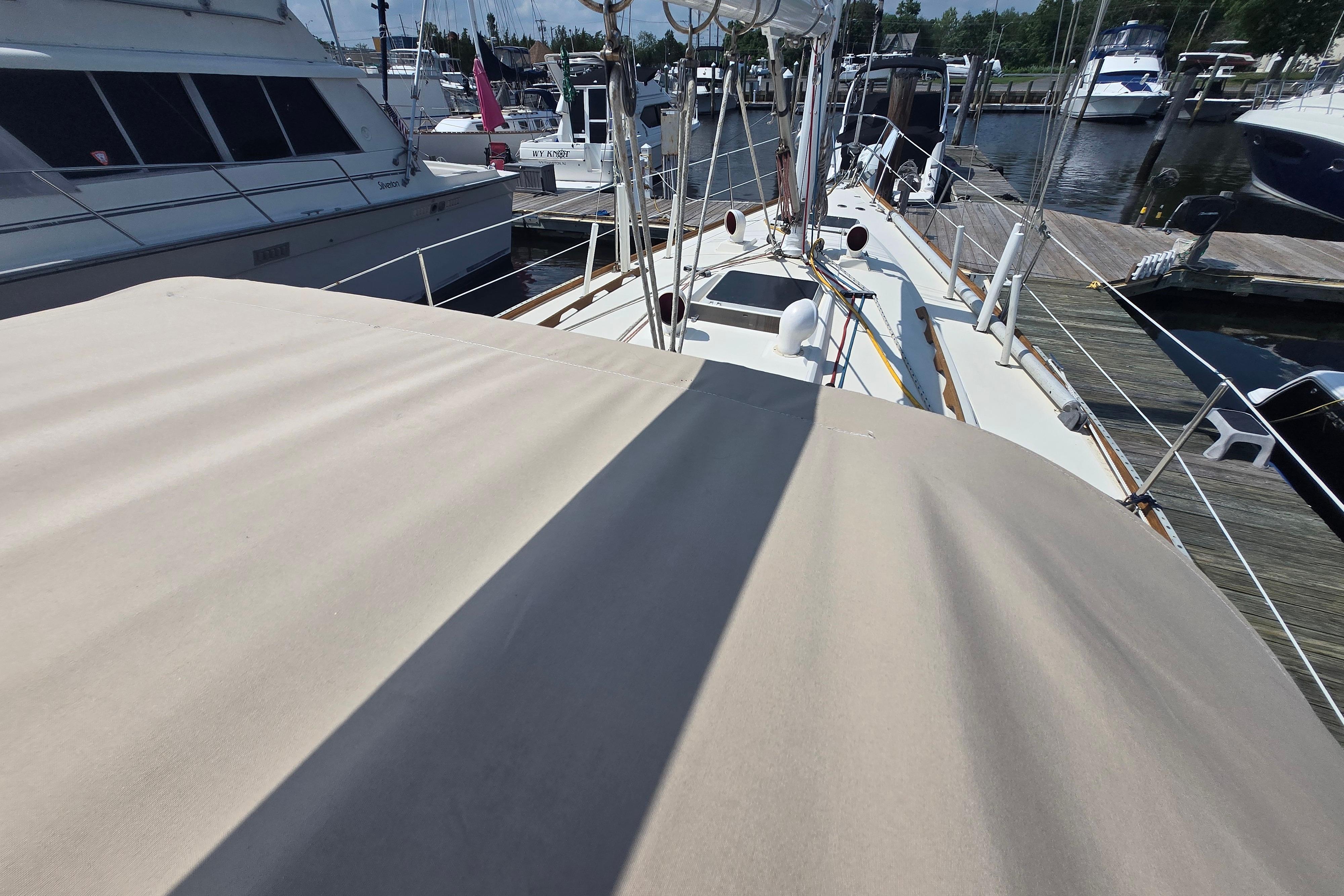 1988 Sabre 38 sailboat docked at marina, view of deck and surrounding boats.