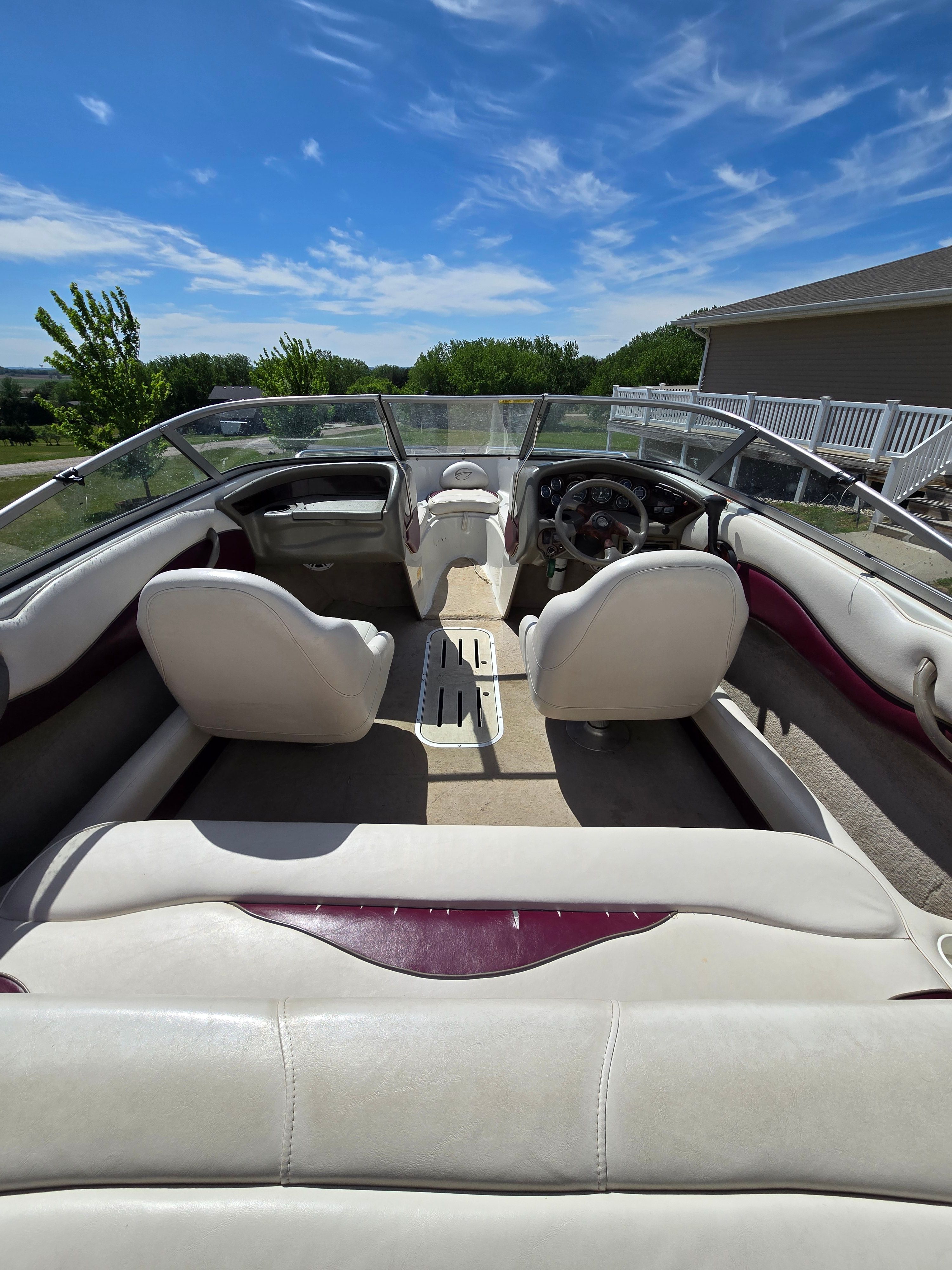 Interior view of a 2001 Crownline 180 BR boat with white seats and clear windshield.