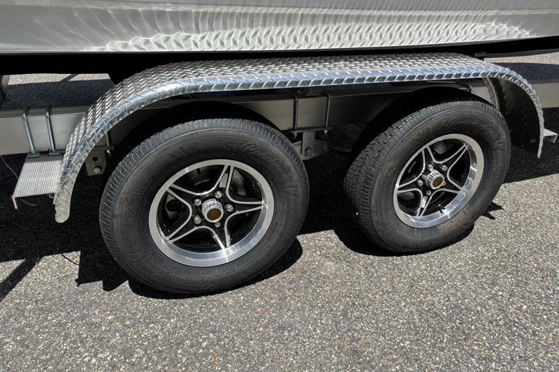 2026 Tahoe 2150 trailer with dual wheels and metallic fender on asphalt.