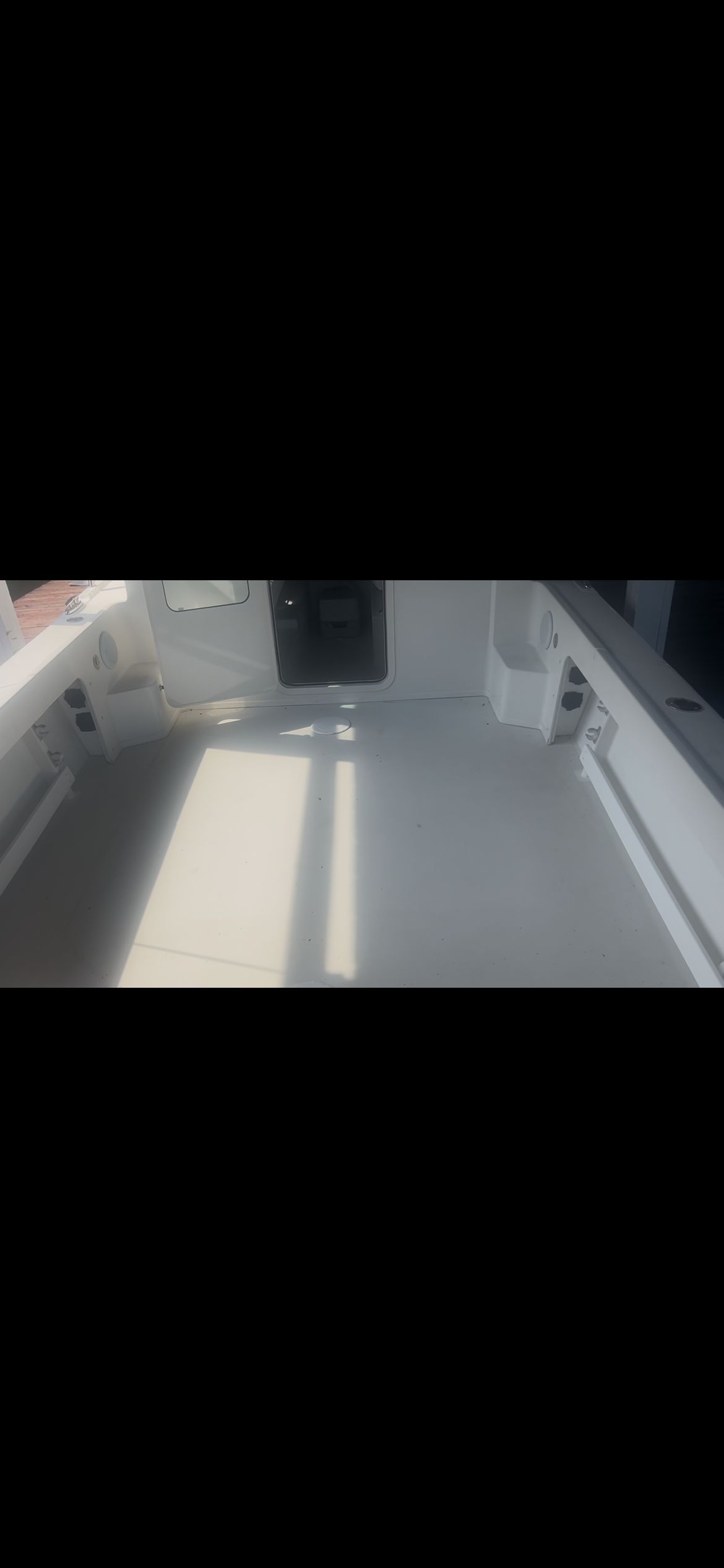 The image shows the empty deck of a Parker 2320 Sport Cabin boat.