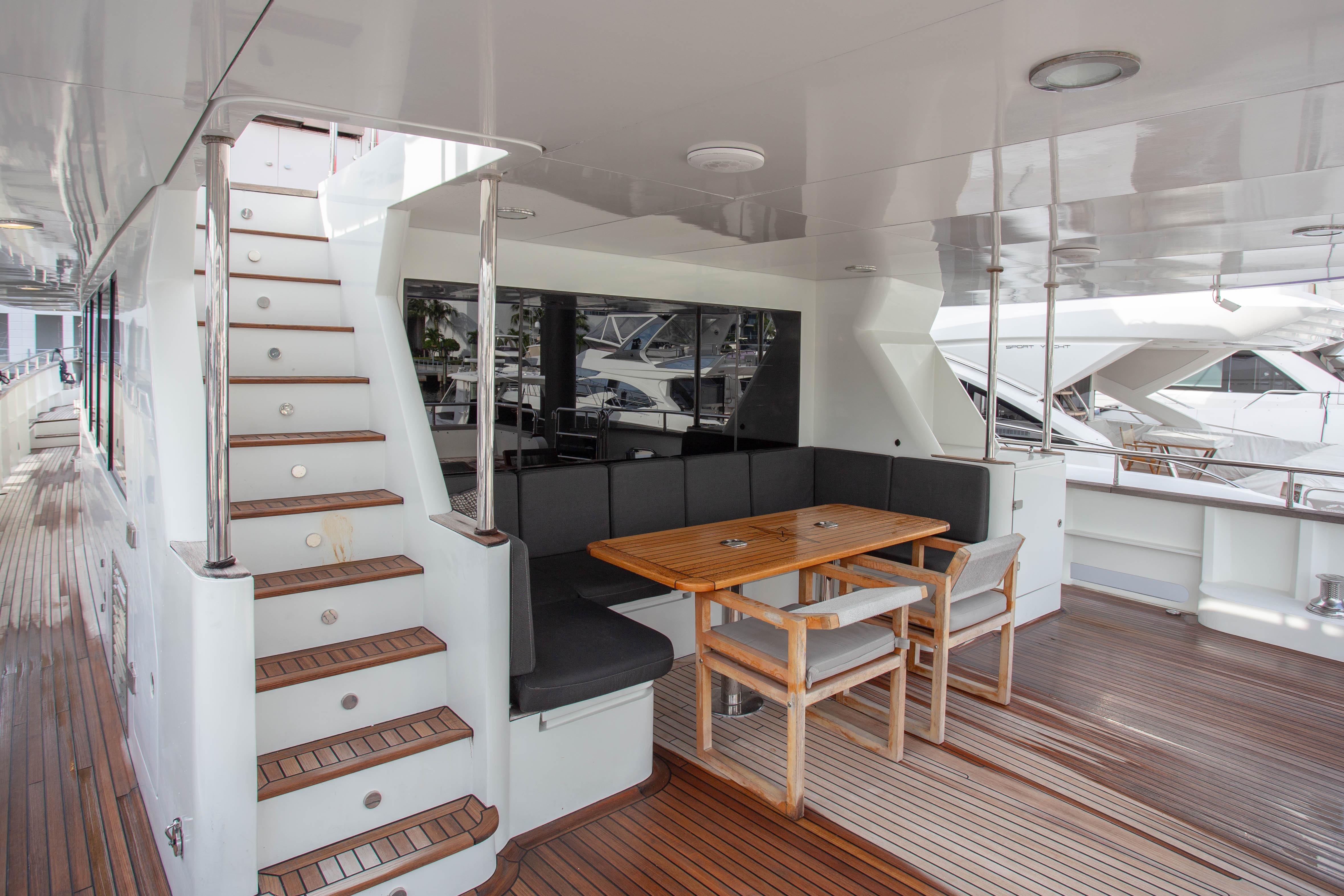 Luxurious 2014 Fifth Ocean Yachts 24m Explorer Yacht deck with seating and staircase.