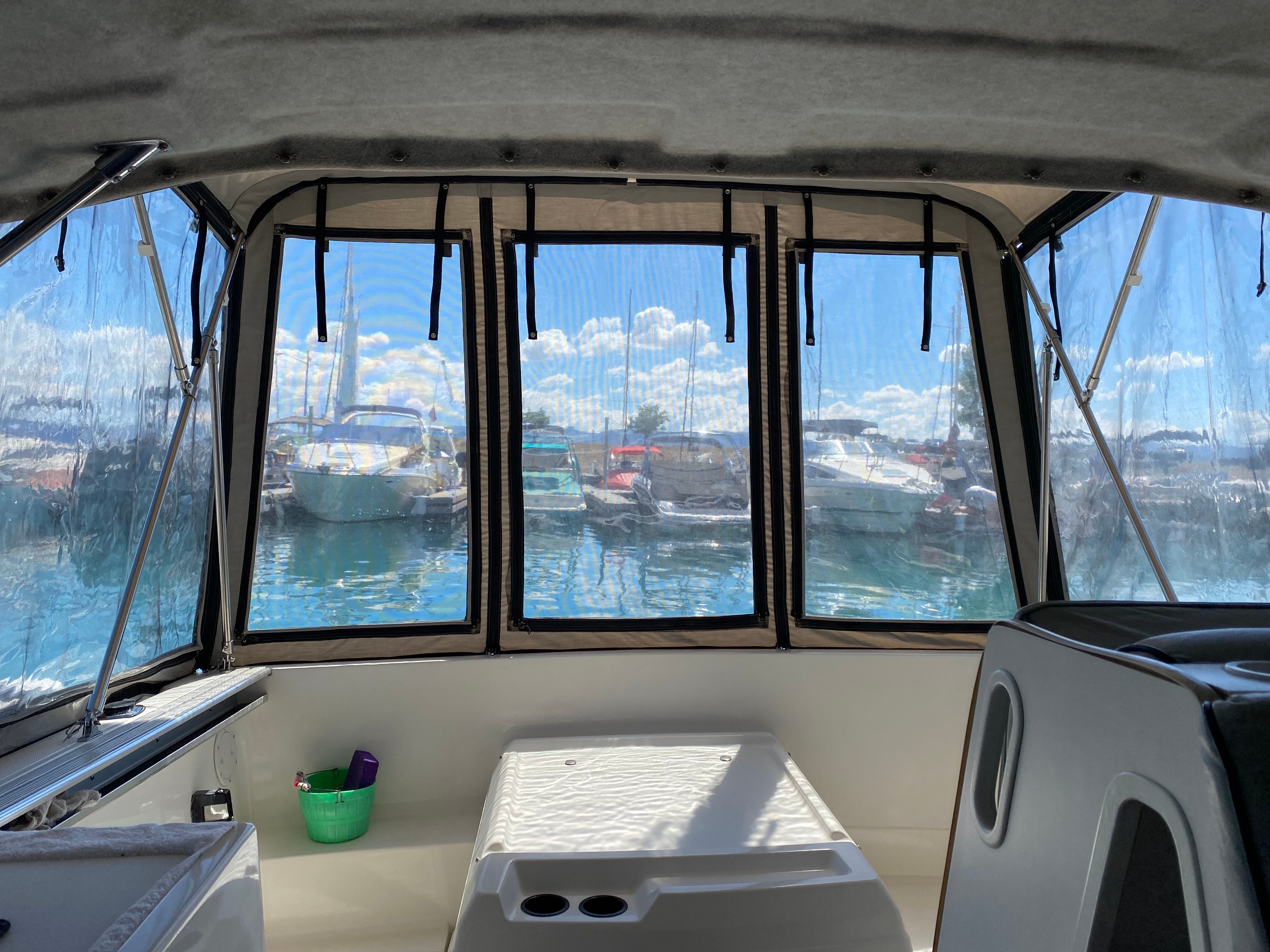 Interior view of a Bayliner 2159 boat overlooking the marina.
