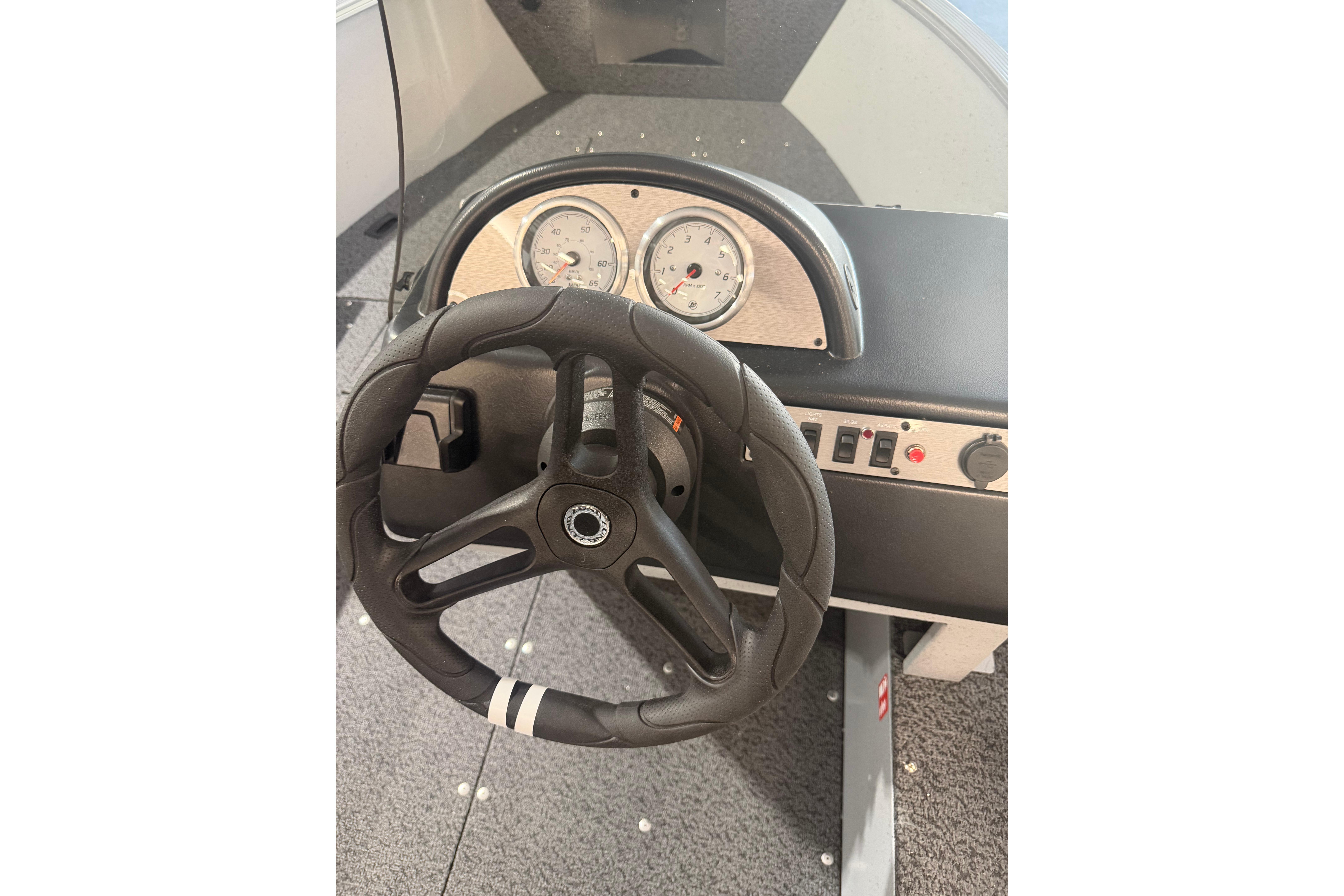 Steering wheel and dashboard of 2027 Lund 1600 Fury SS boat.