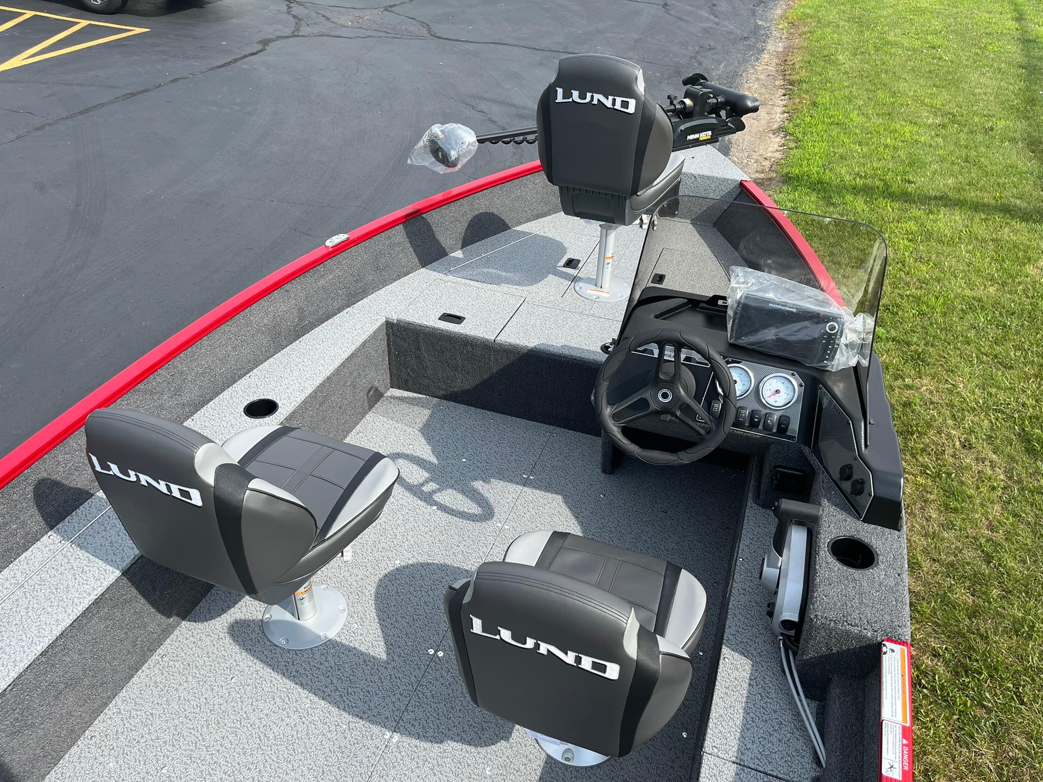 2026 Lund 1650 Angler SS boat interior with steering console and seating.