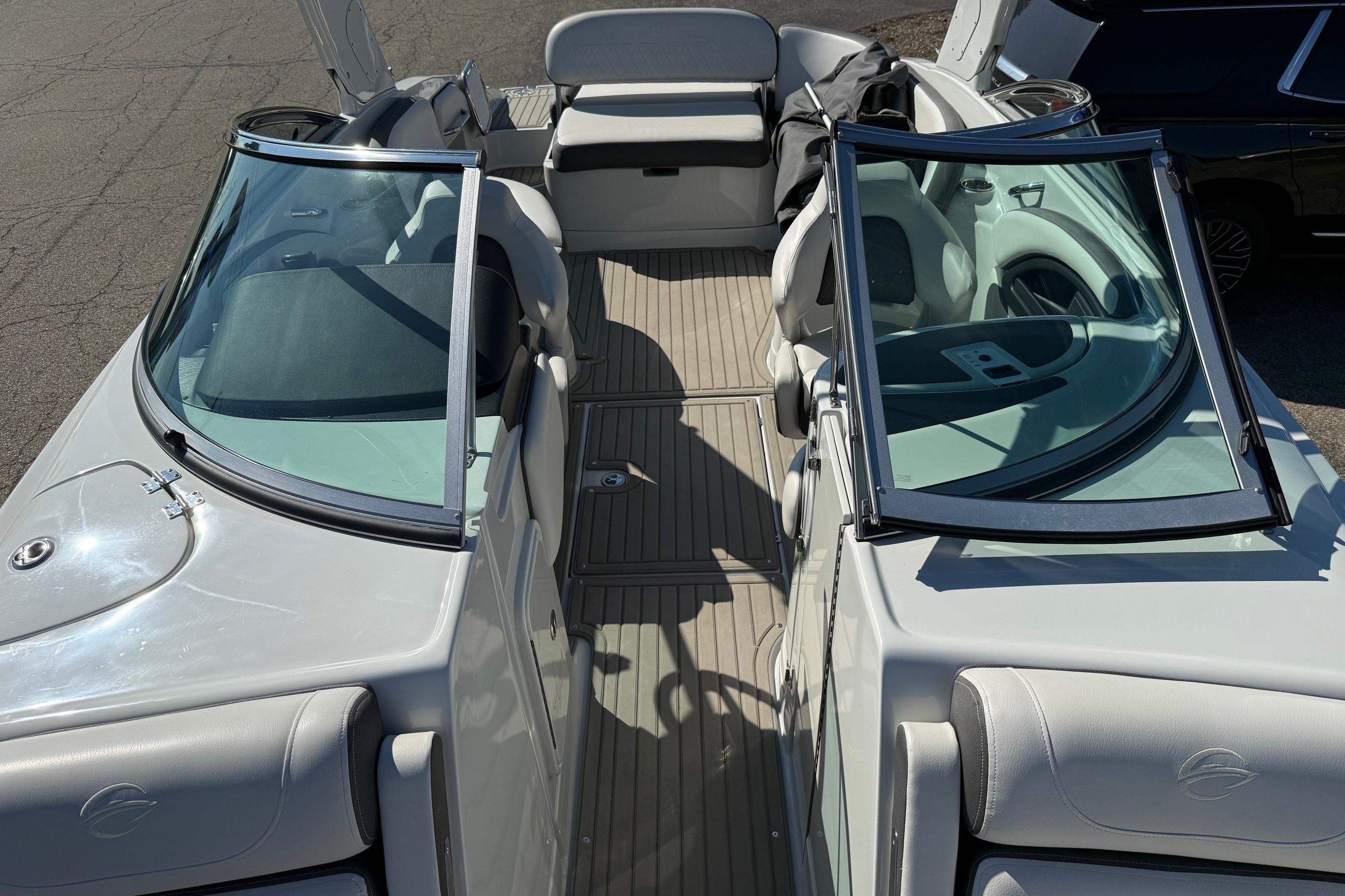 2023 Crownline 290 SS boat interior with open windshield and seating area.