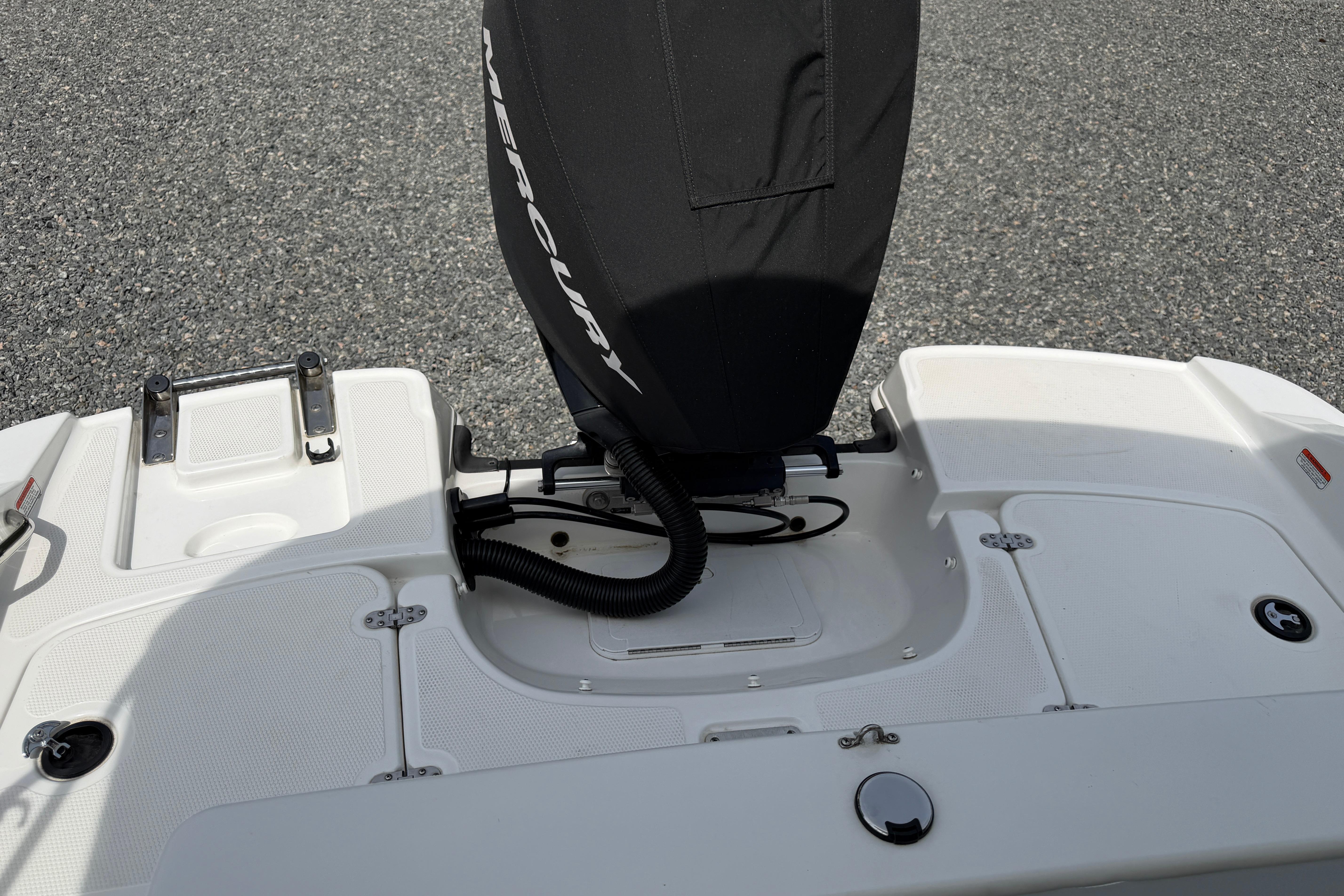 2022 Tahoe 2150 boat stern with Mercury engine cover, white deck, and swim platform.