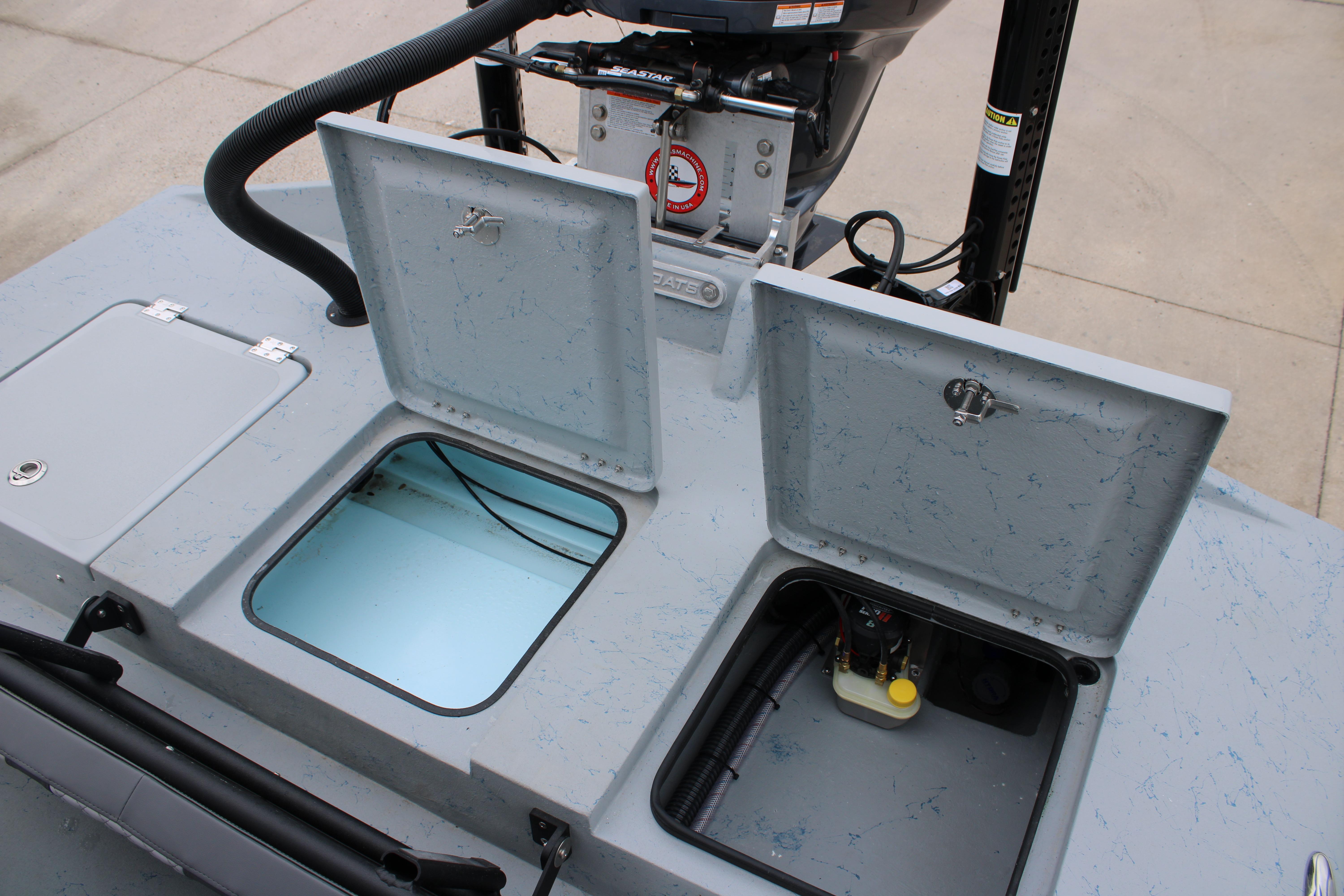 2026 Tahoe T16 boat storage compartments with open hatches, showcasing interior details.