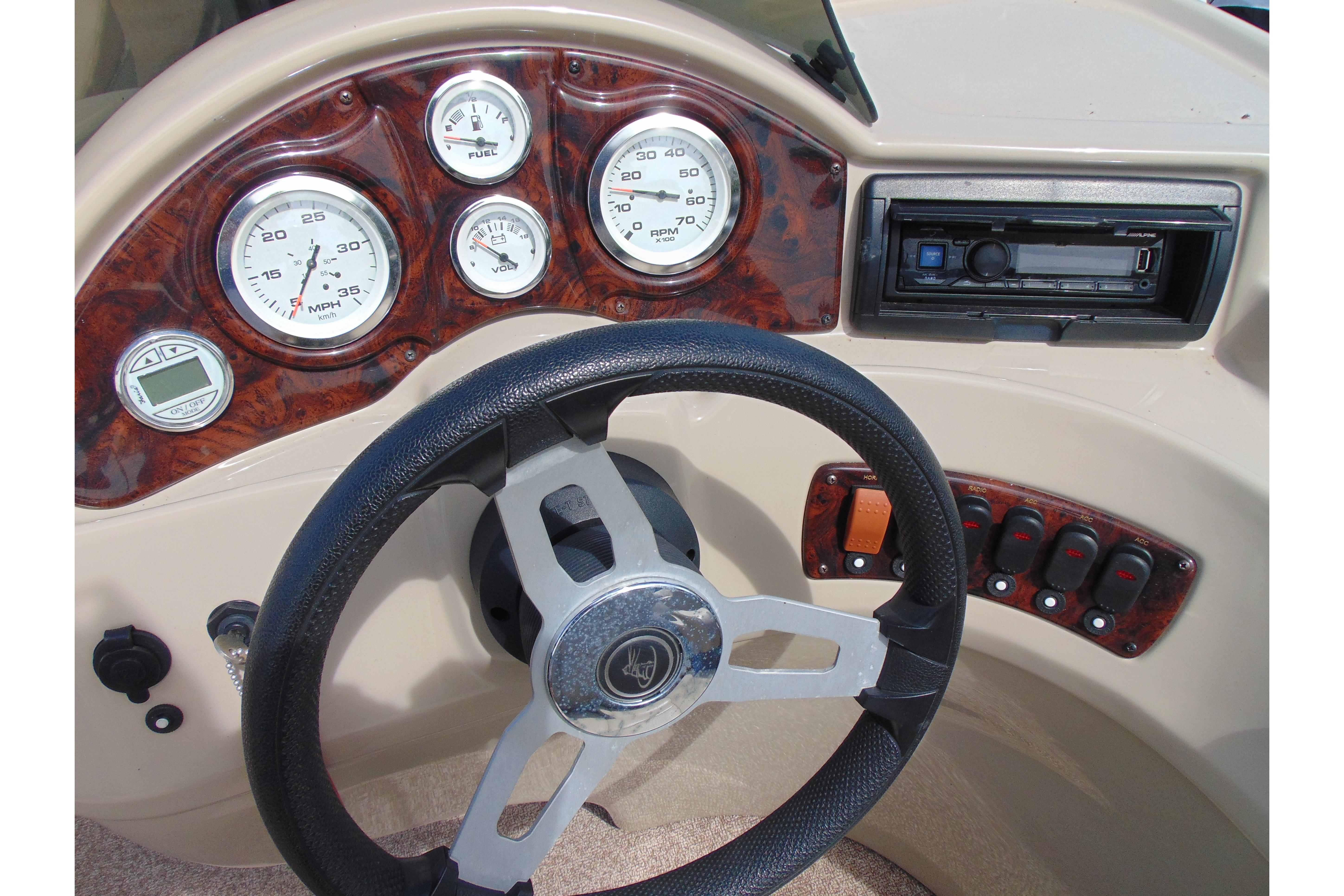 Steering console of 2016 Misty Harbor 245 Adventure CU with gauges and controls.