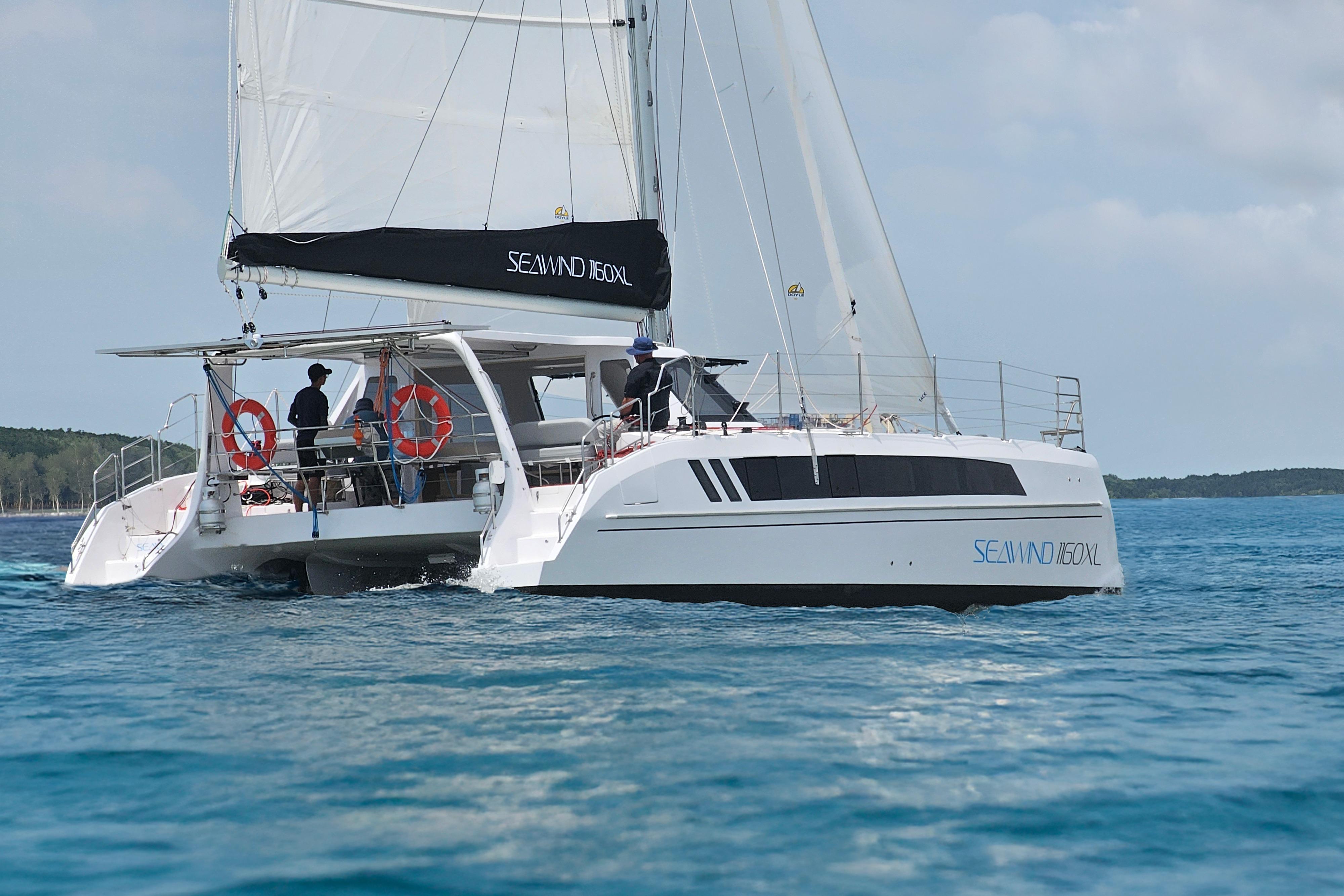 2026 Seawind 1160XL catamaran sailing on clear blue water.