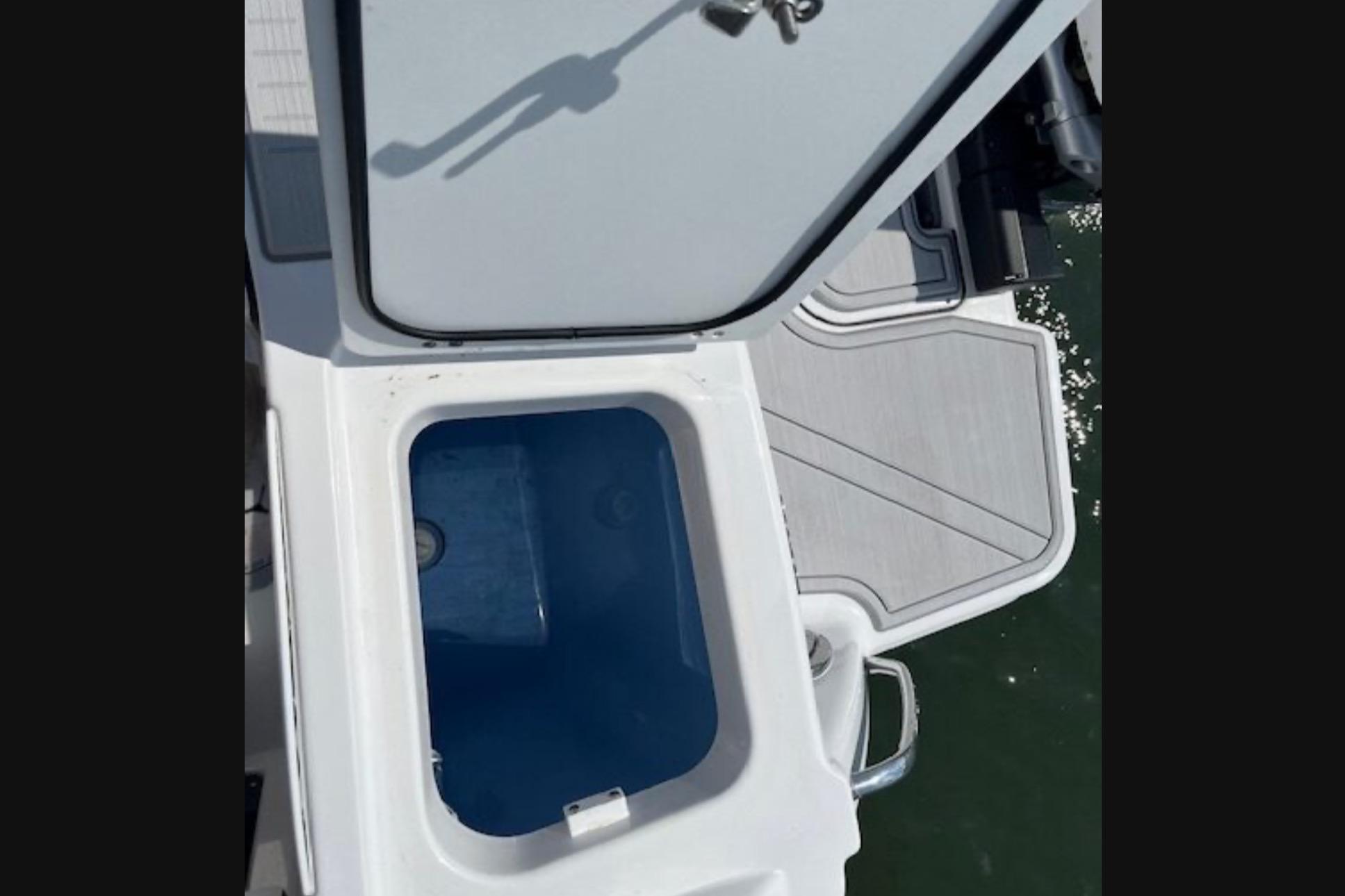 2024 Blackfin 302 DC boat with open storage compartment on deck.