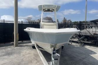 2024 Boston Whaler 220 Dauntless boat on trailer, parked outdoors.