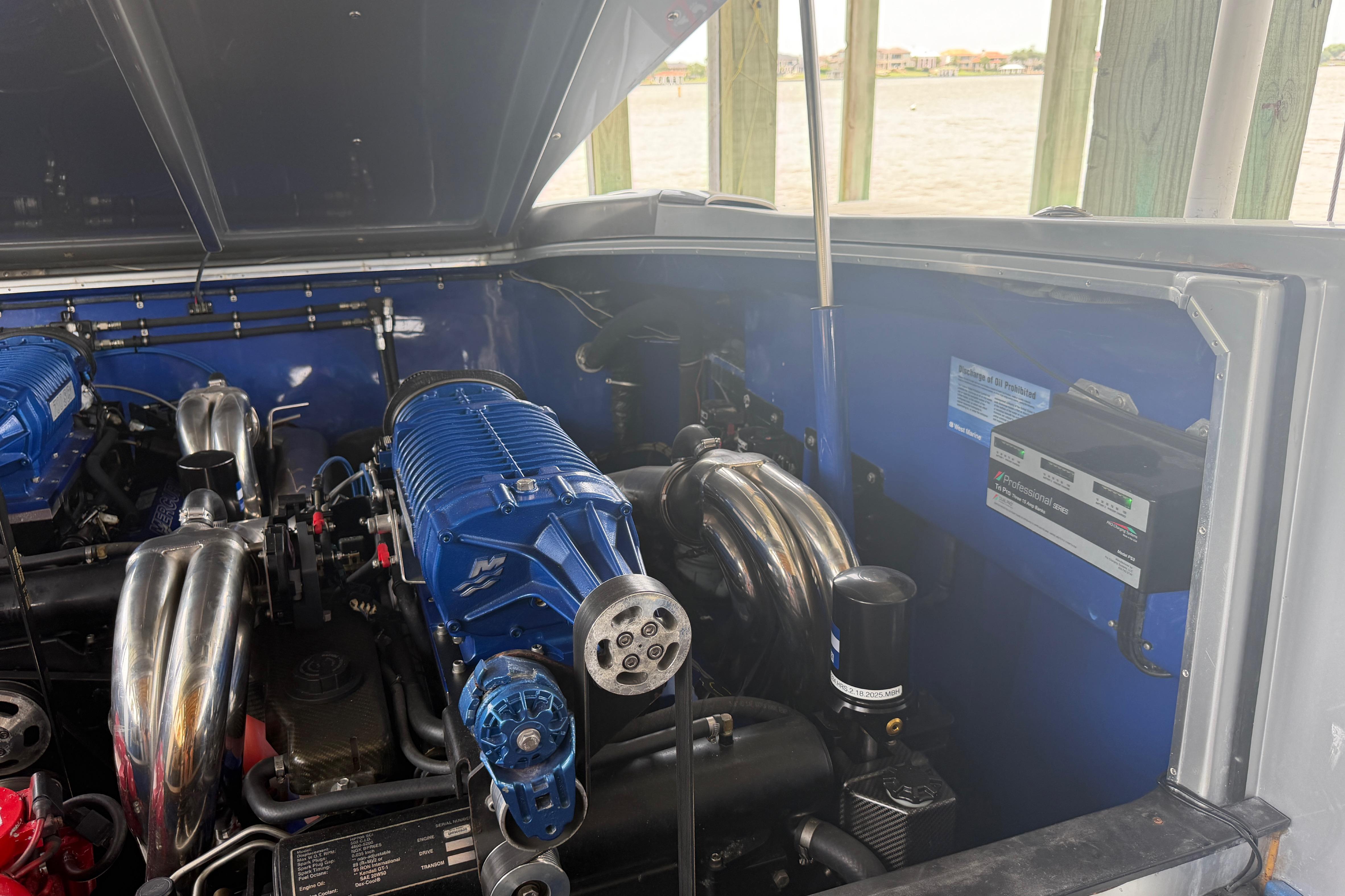 Engine compartment of a 2013 Nor-Tech 477 SPX Vee Bottom boat, showcasing dual engines.