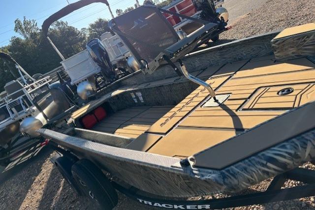 2026 Tracker Grizzly 1756 T Marsh boat with camo design, parked outdoors.