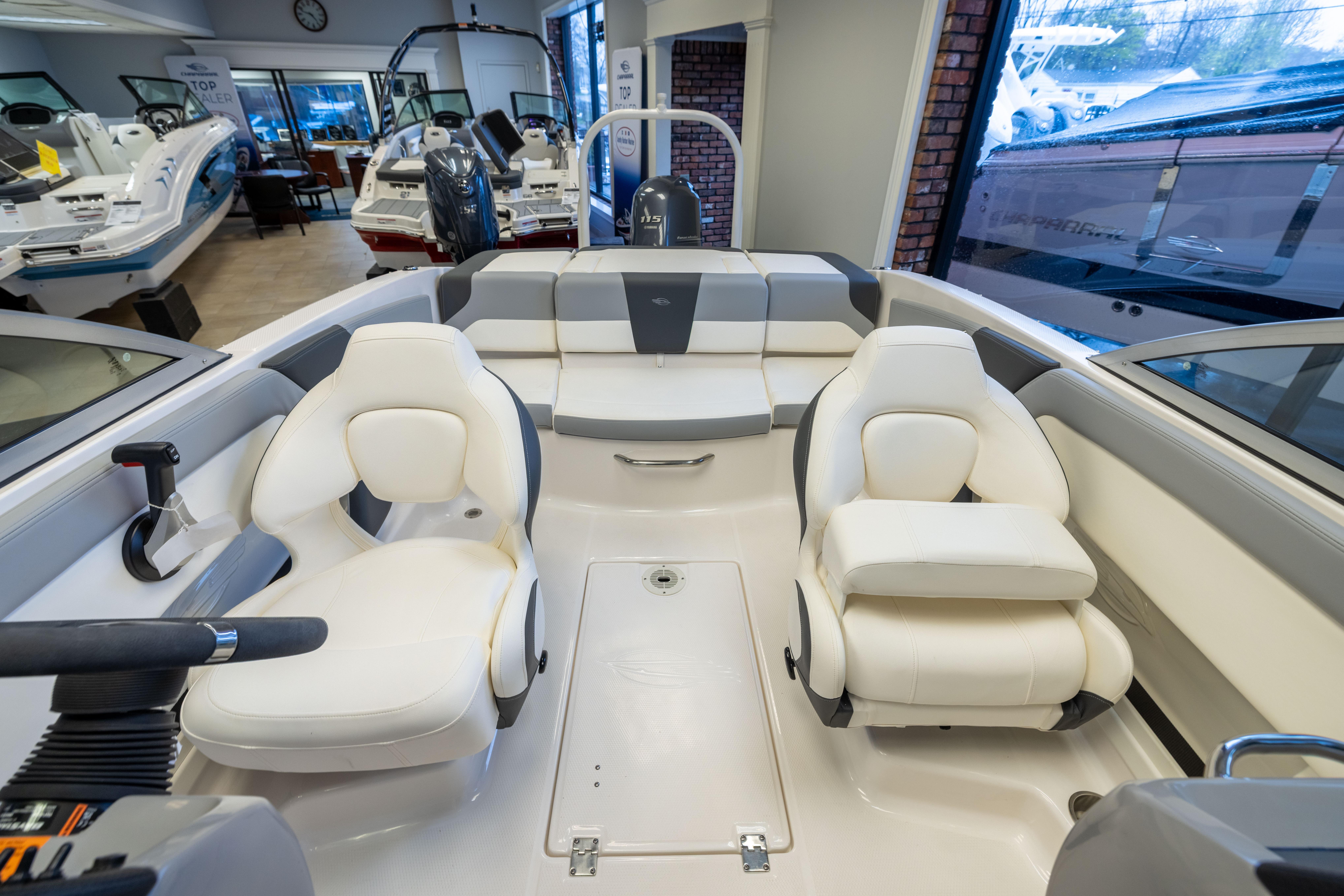 2024 Chaparral 19 SSi OB boat interior with white seating in showroom.