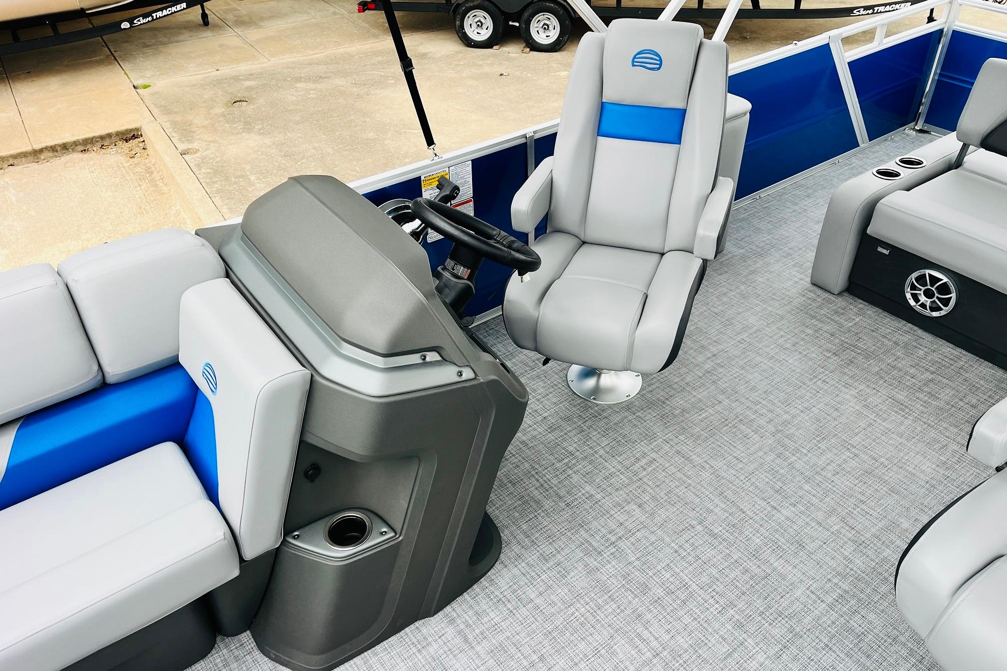 2026 Sun Tracker Party Barge 22 RF DLX interior with gray and blue seating.