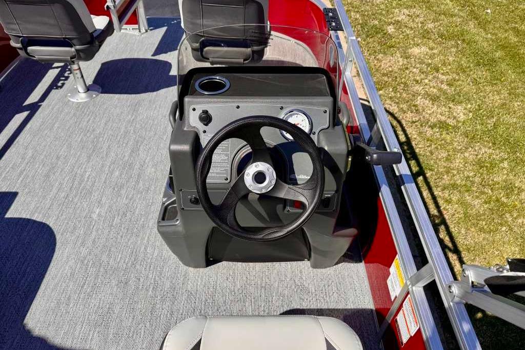 2026 Sun Tracker Bass Buggy 16 XL Select boat dashboard with steering wheel and seating.