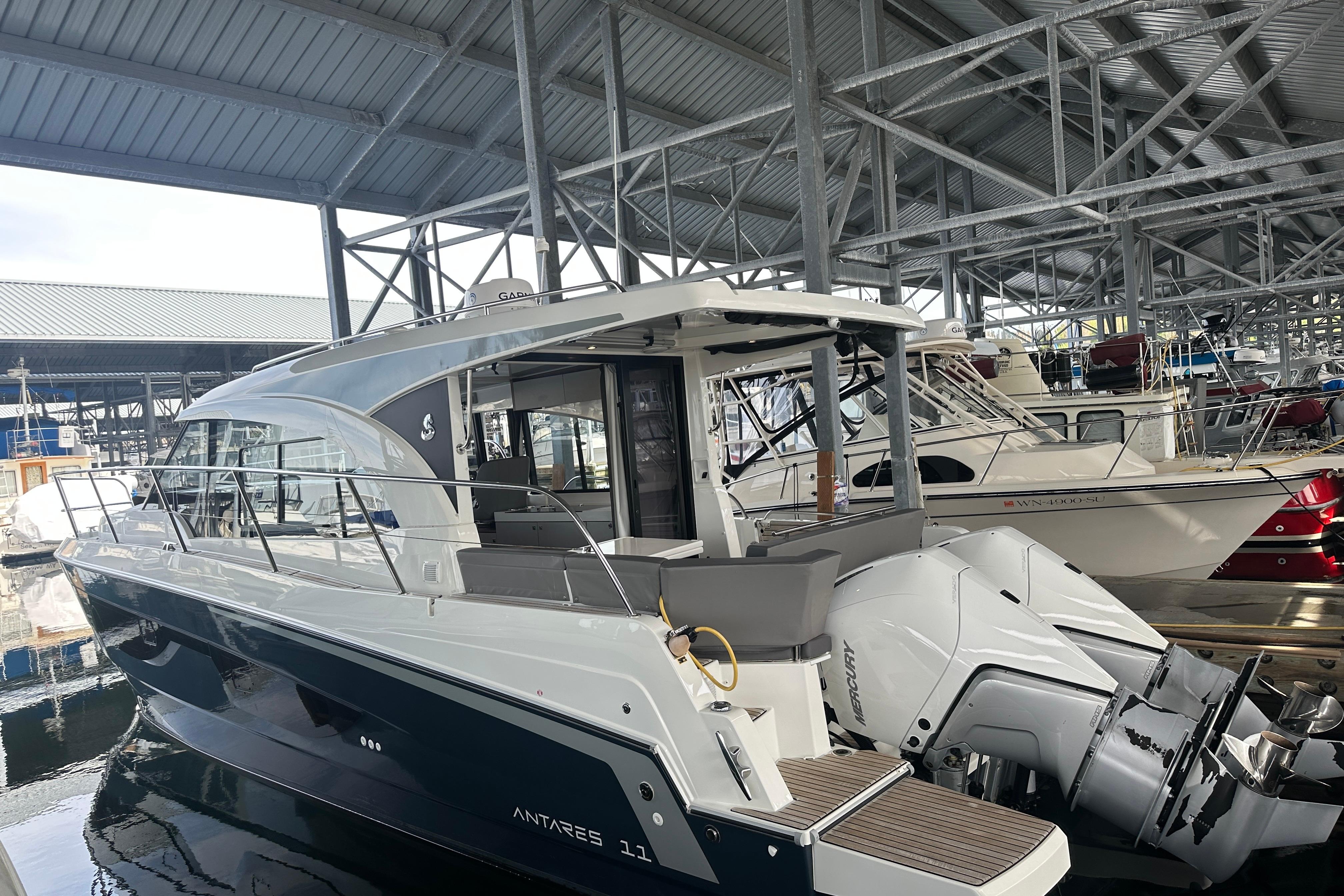 2023 Beneteau Antares 11 Coupe docked in a covered marina.