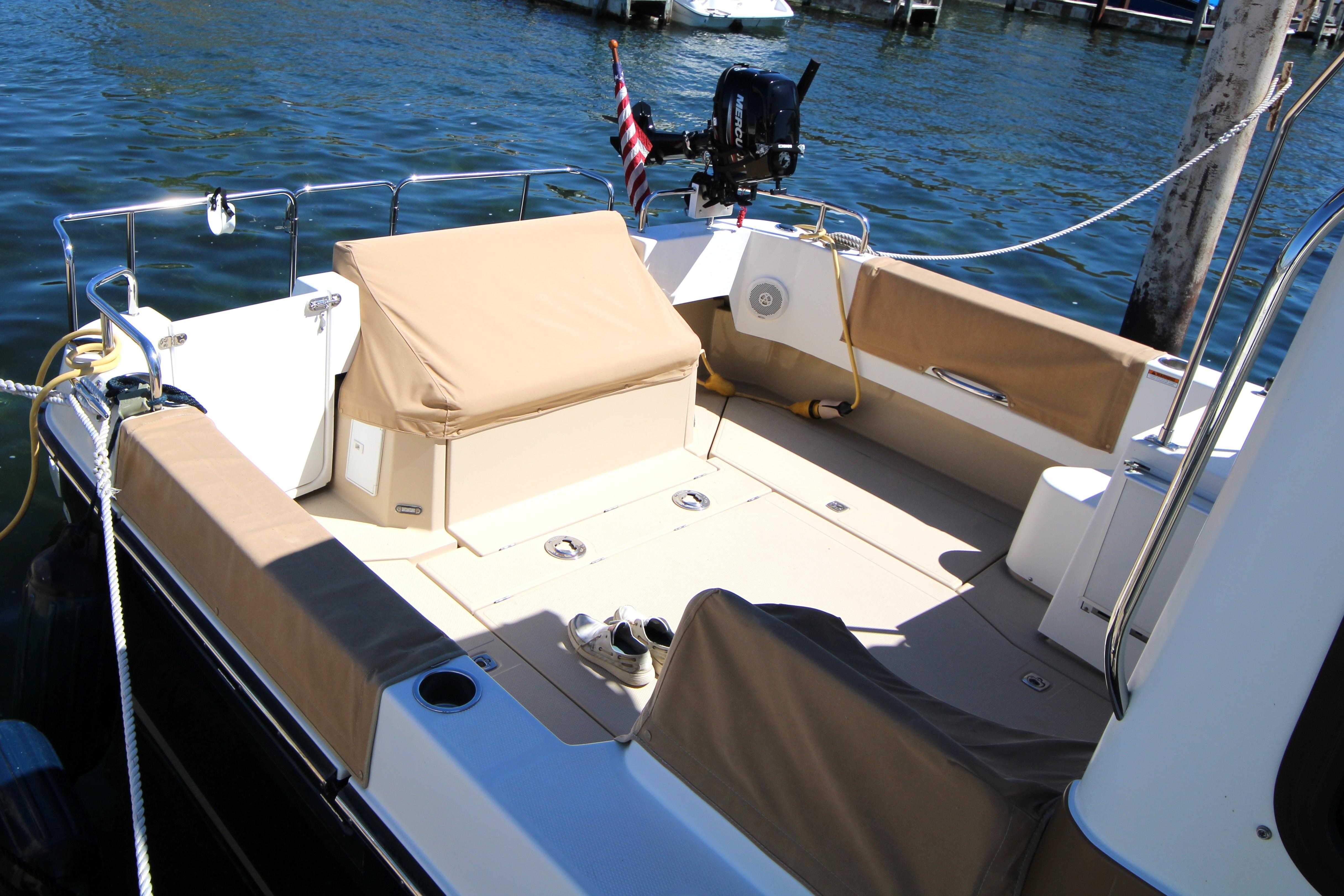 2013 Ranger Tugs R-31 CB boat deck with seating, moored by the water.