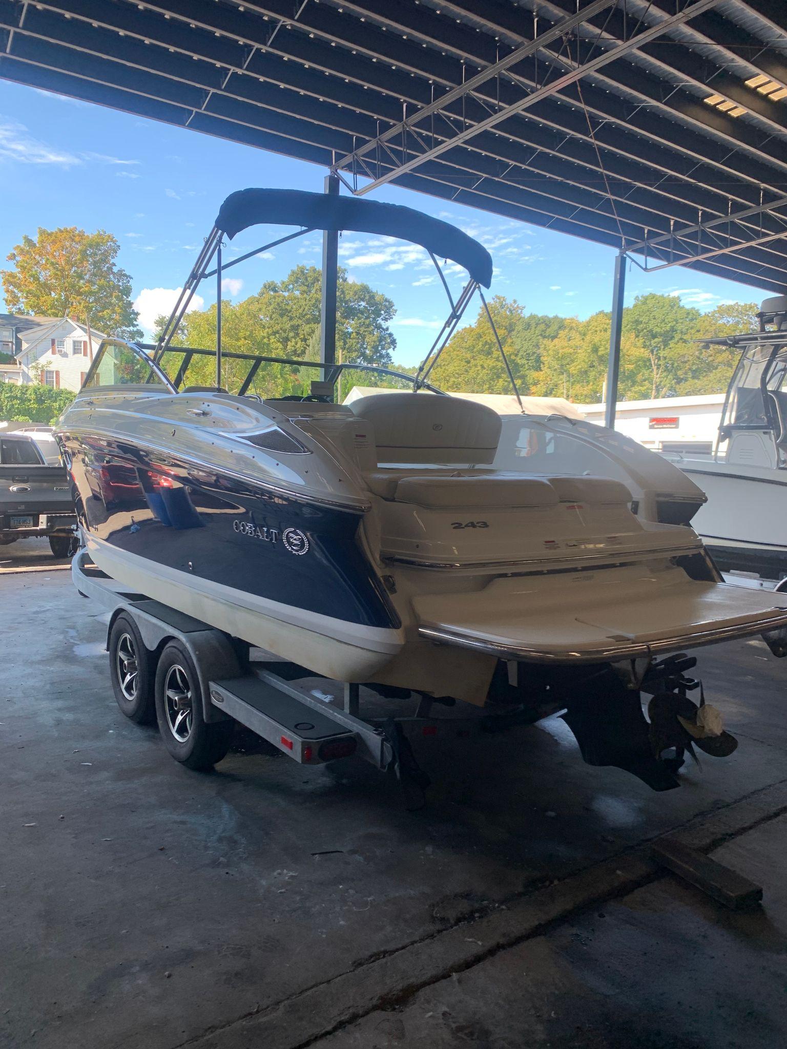 2015 Cobalt 243 boat parked in a storage facility.