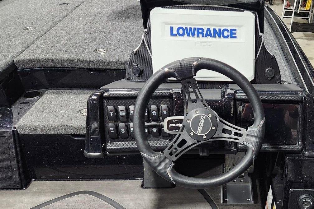 2026 Triton 20XP Patriot boat dashboard with Lowrance display and steering wheel.