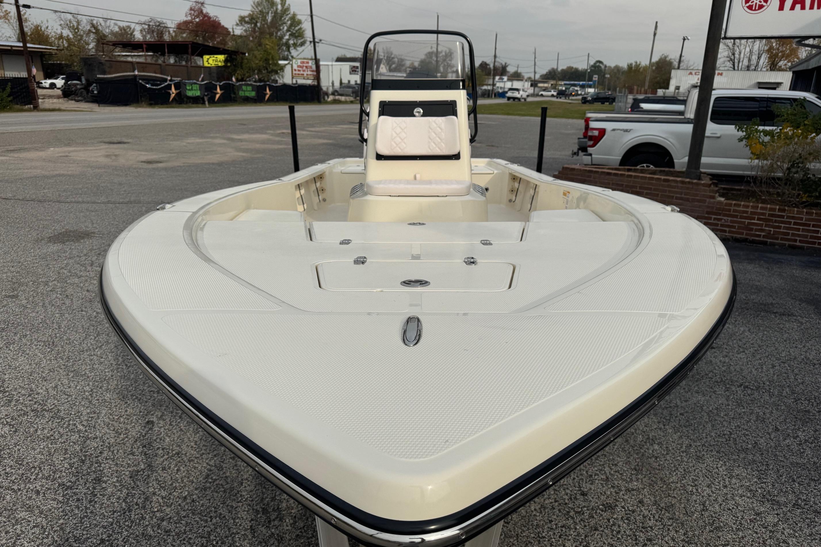 2026 BlackJack 224 boat, front view, parked on pavement with background vehicles.