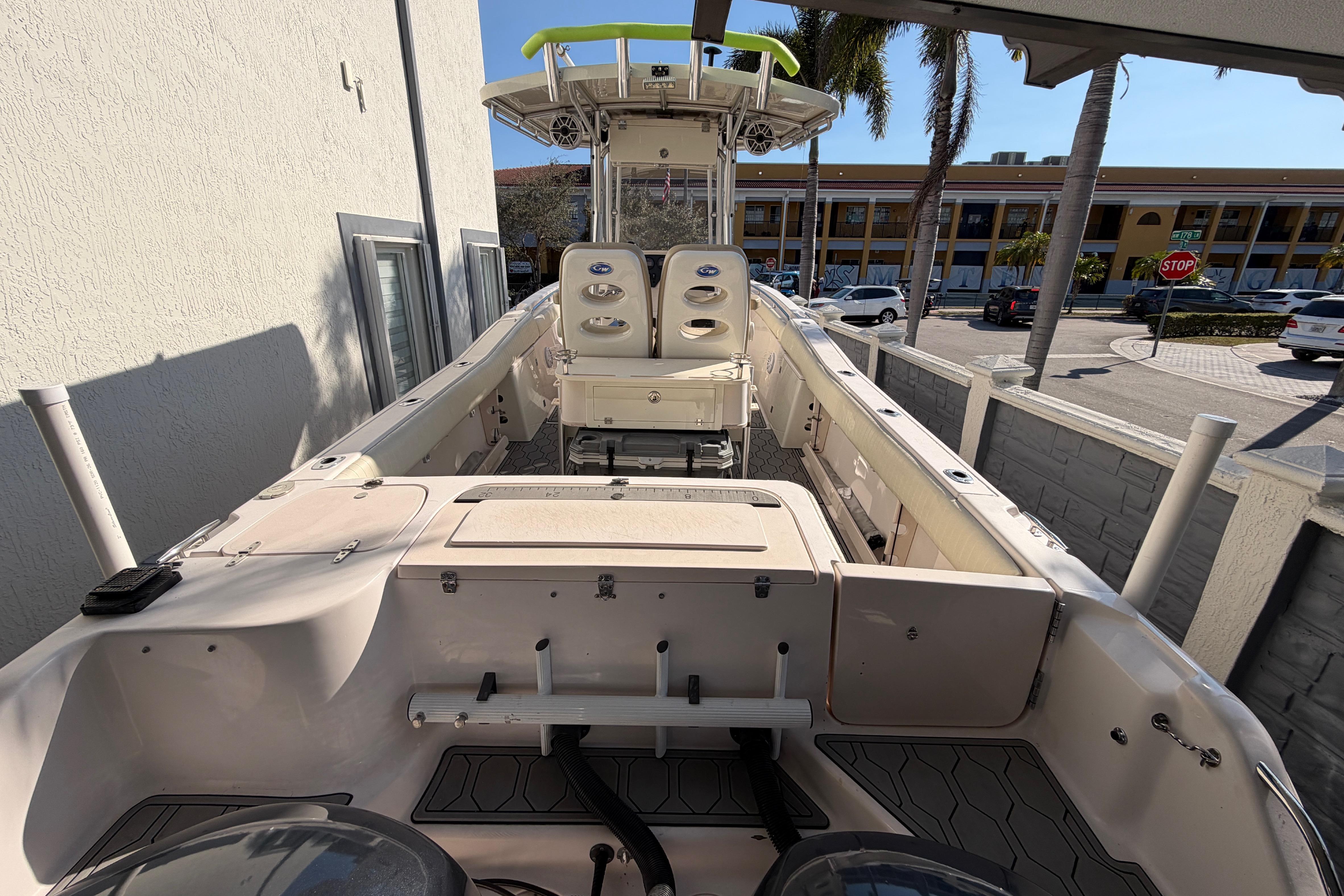 2004 Grady White 273 boat docked, featuring spacious deck and seating, under clear skies.