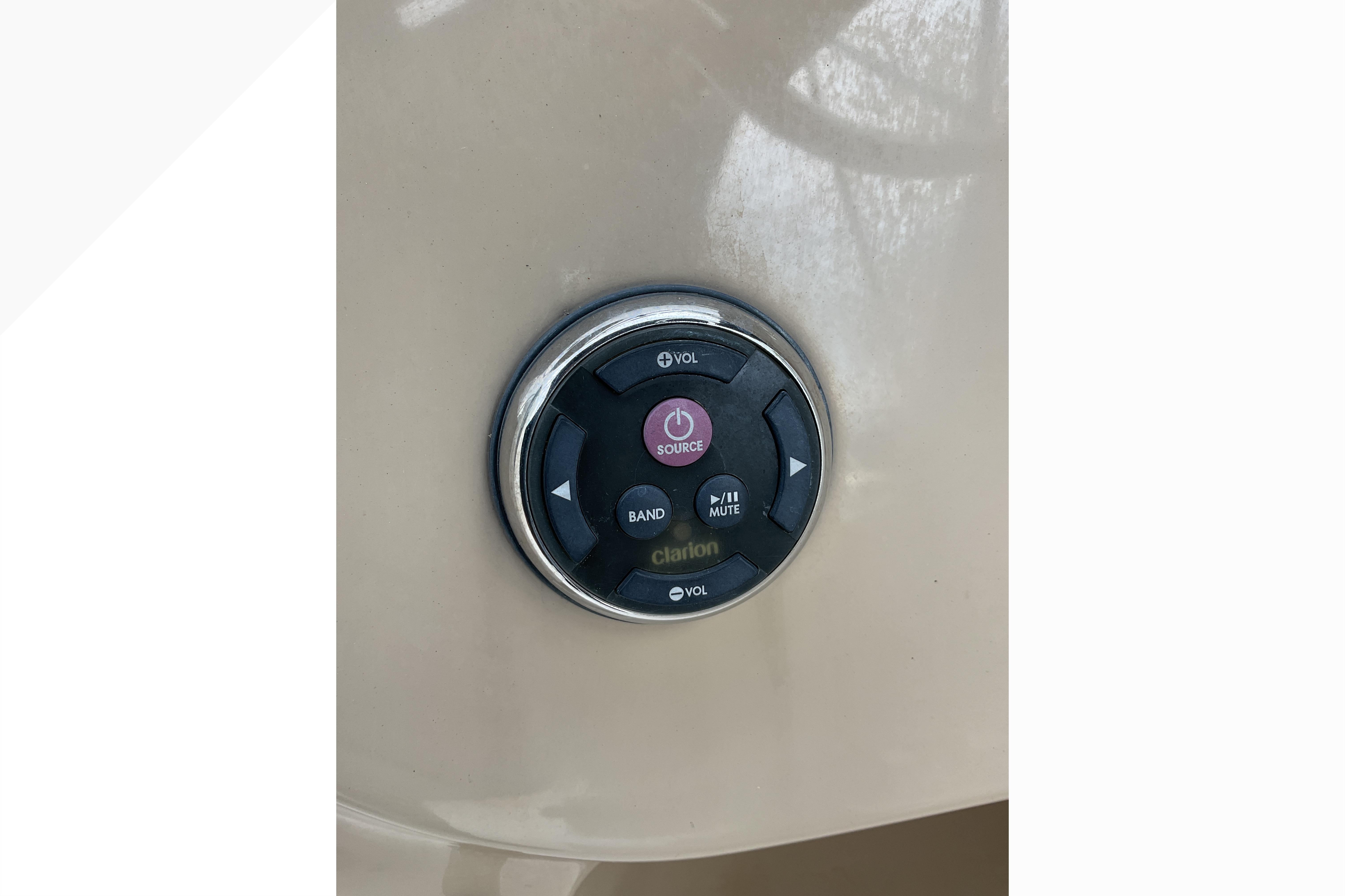 Audio control panel on a 2012 Wellcraft 232 Coastal boat dashboard.