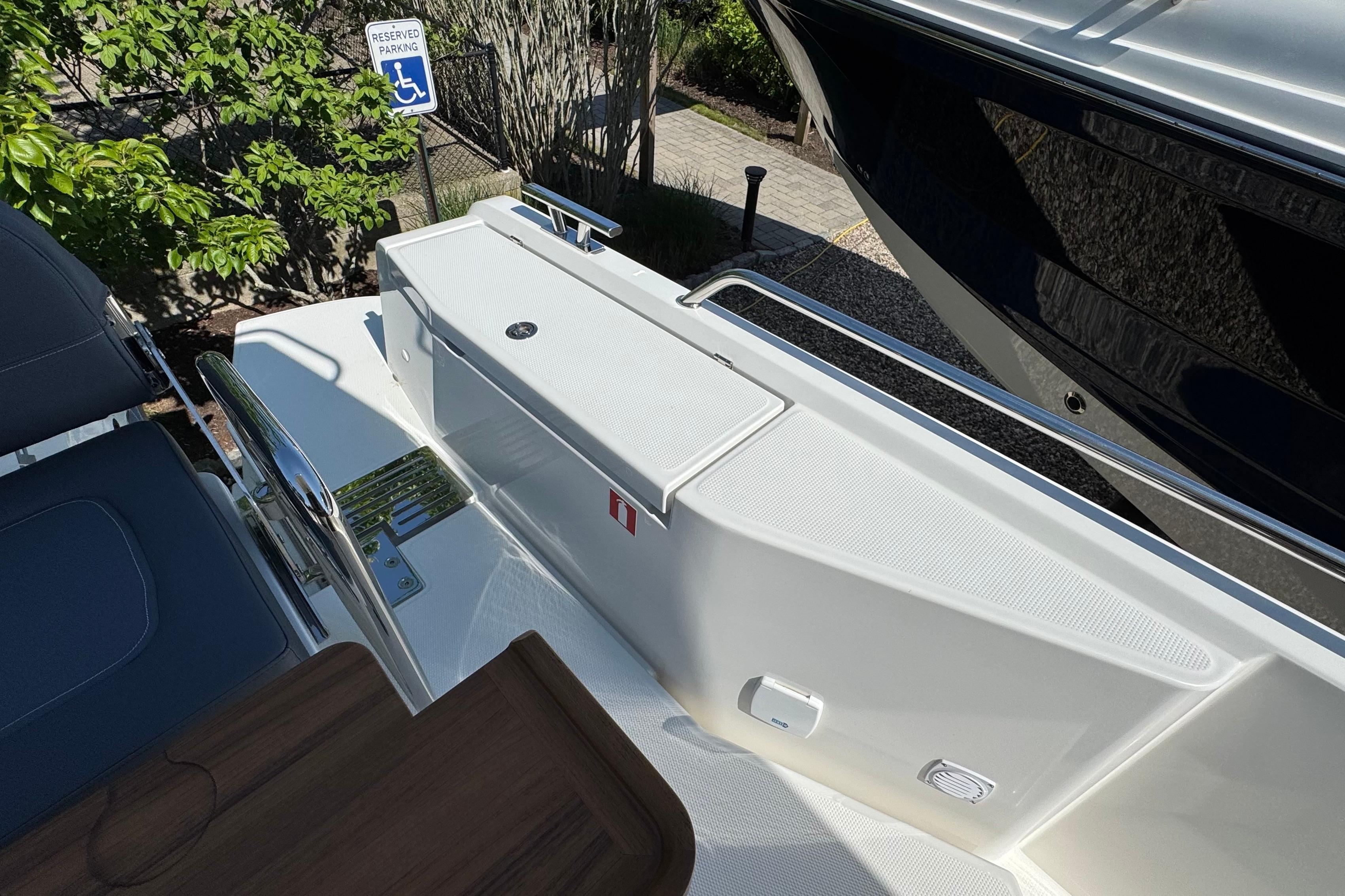 Nimbus Commuter 11 boat, 2025, with seating area and reserved parking sign.