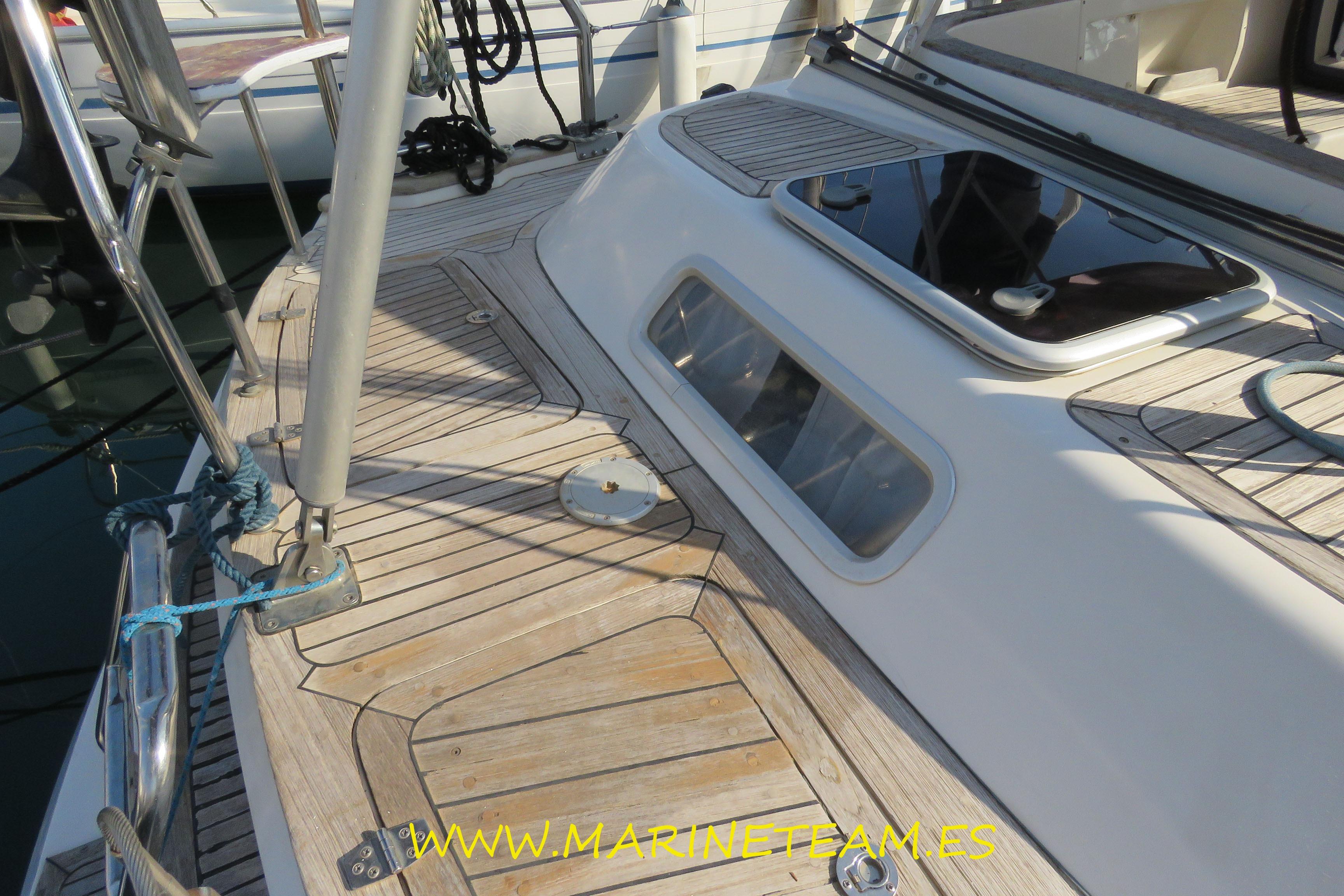 Deck of 2002 Najad 373 sailboat with teak finish and hatch.