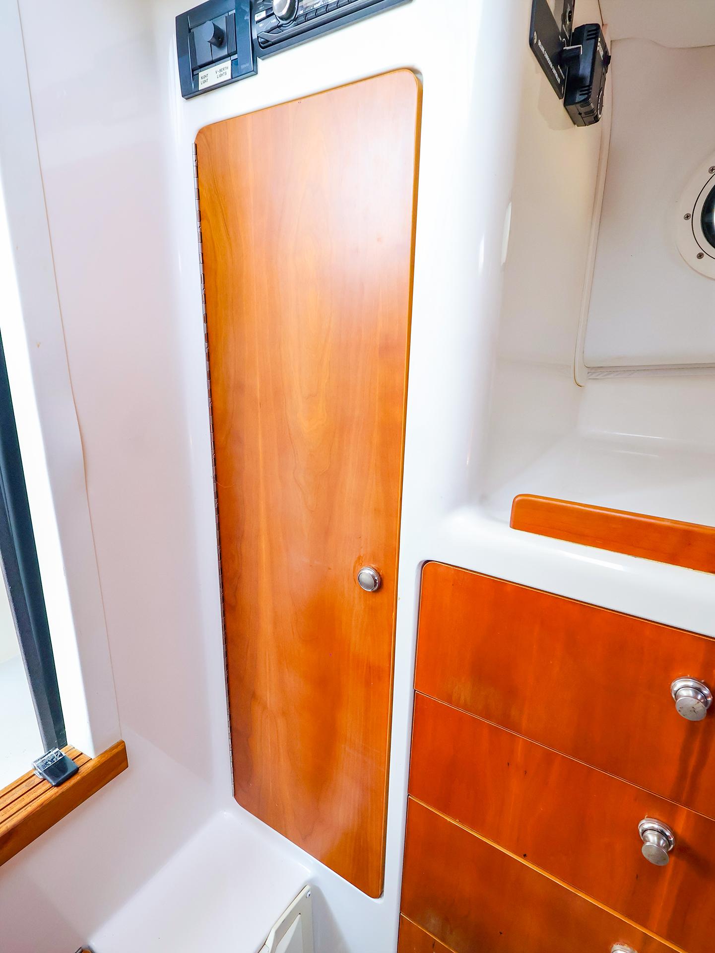 Wooden cabinet and drawers inside a 2004 True North 38 boat interior.