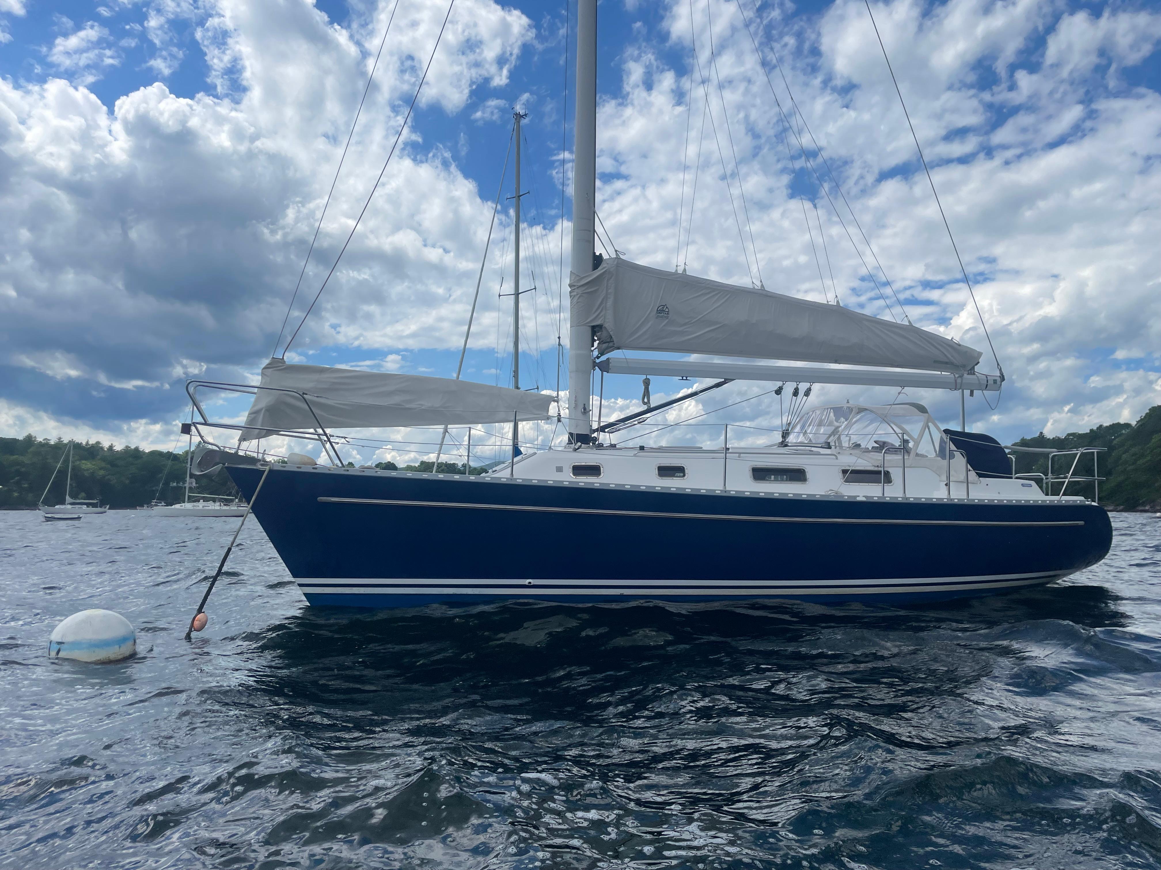1993 Freedom 35 sailboat on water under cloudy sky.