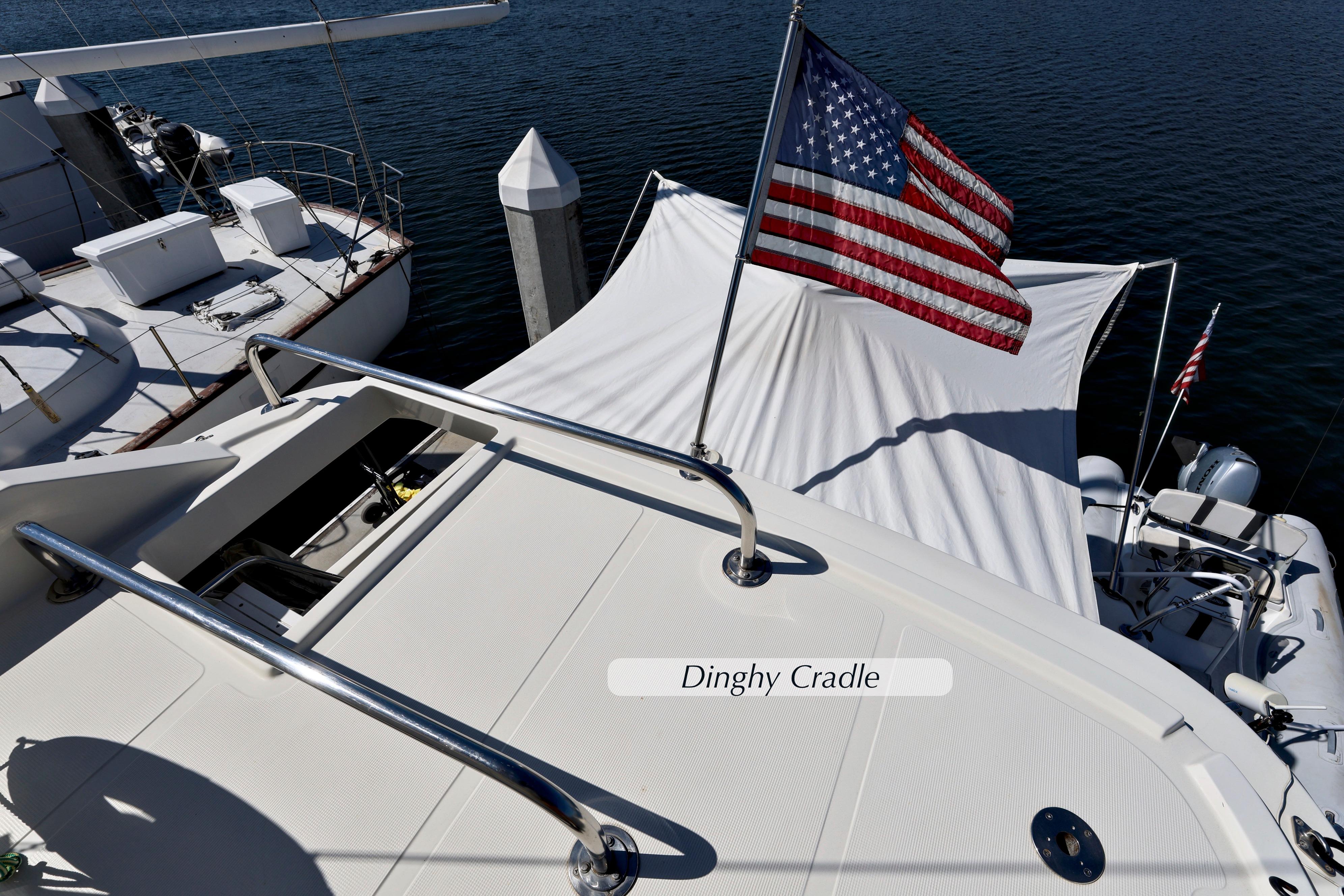 2004 McKinna 57 Pilothouse yacht with American flag and dinghy cradle.