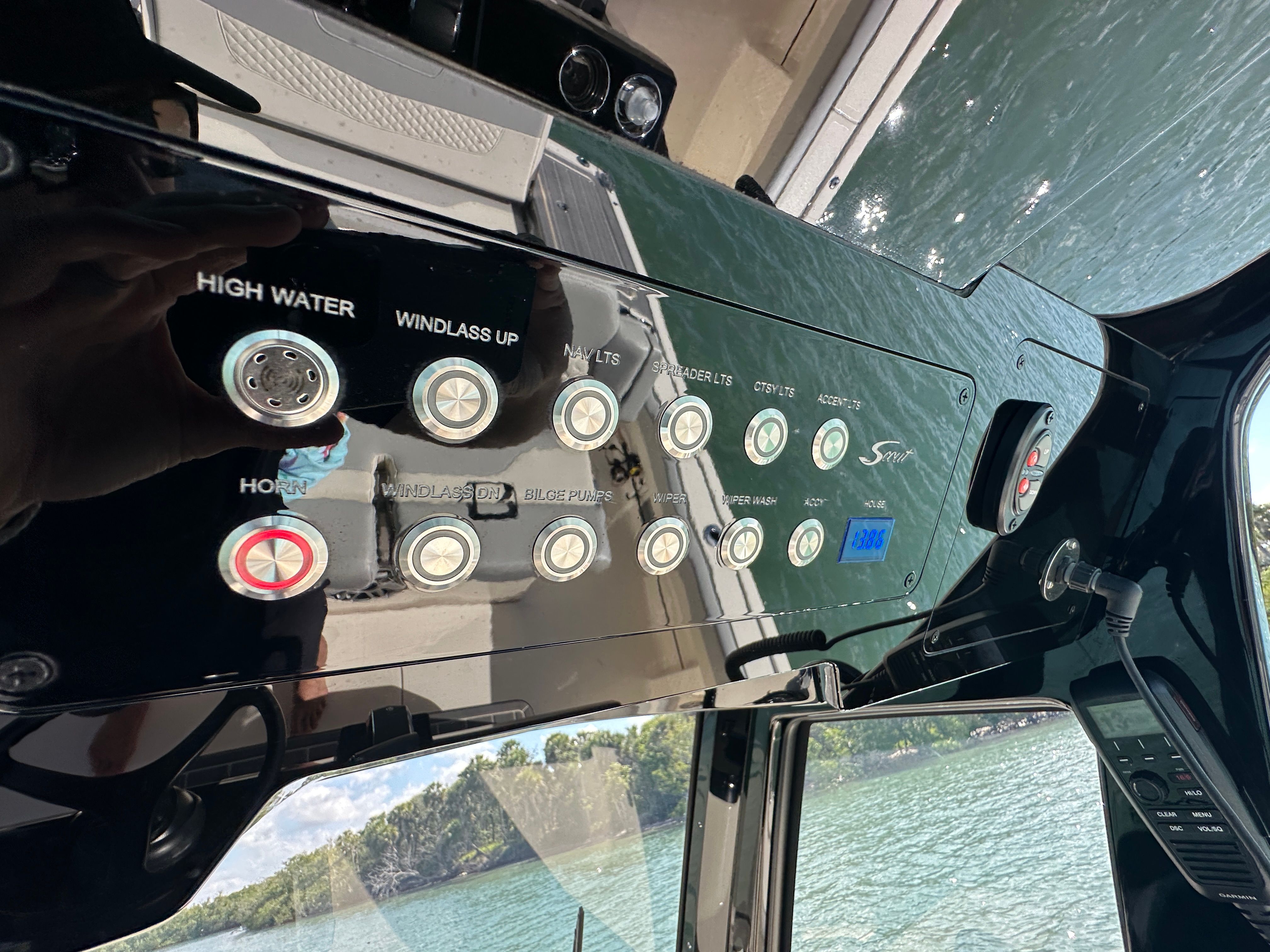 Dashboard of a Scout 281 XSS boat with various switches and indicators.