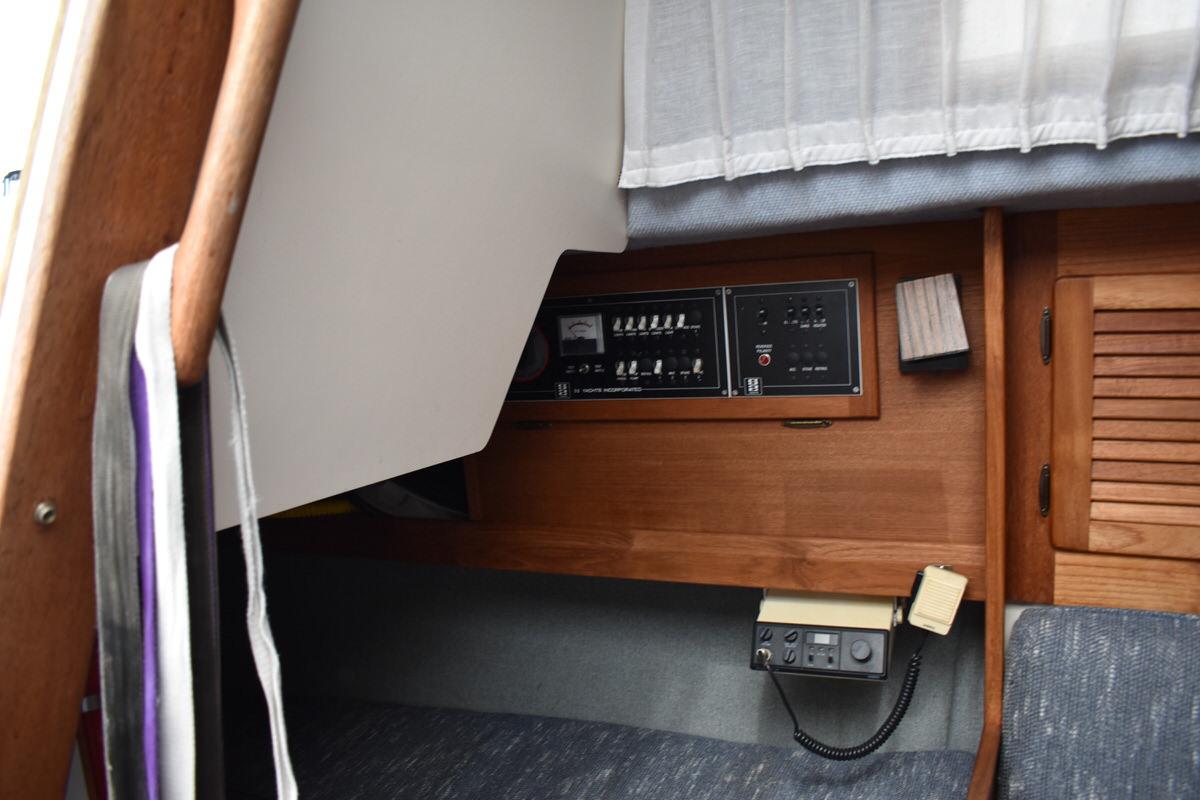 Interior view of a 1987 S2 9.2A yacht with control panel and wooden furnishings.