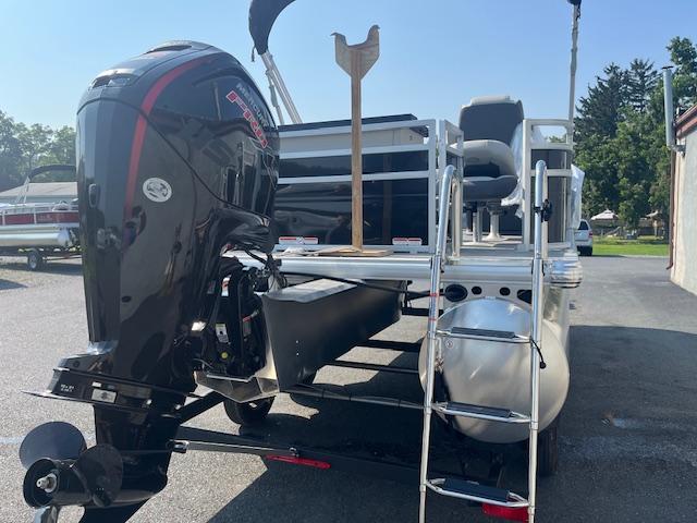 2026 Sun Tracker Fishin' Barge 20 DLX pontoon boat with powerful outboard motor.