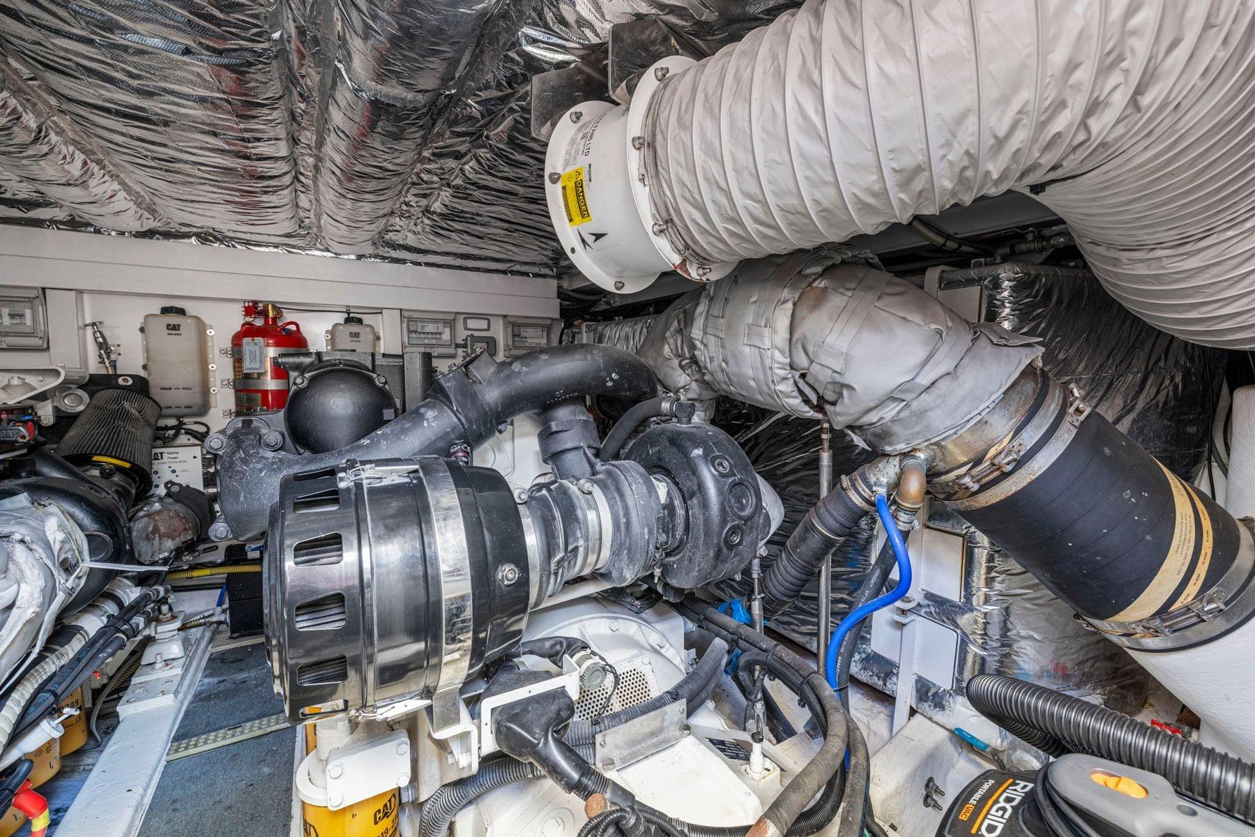 Engine room of 2015 Princess 60 Flybridge Motor Yacht, showcasing complex machinery and components.