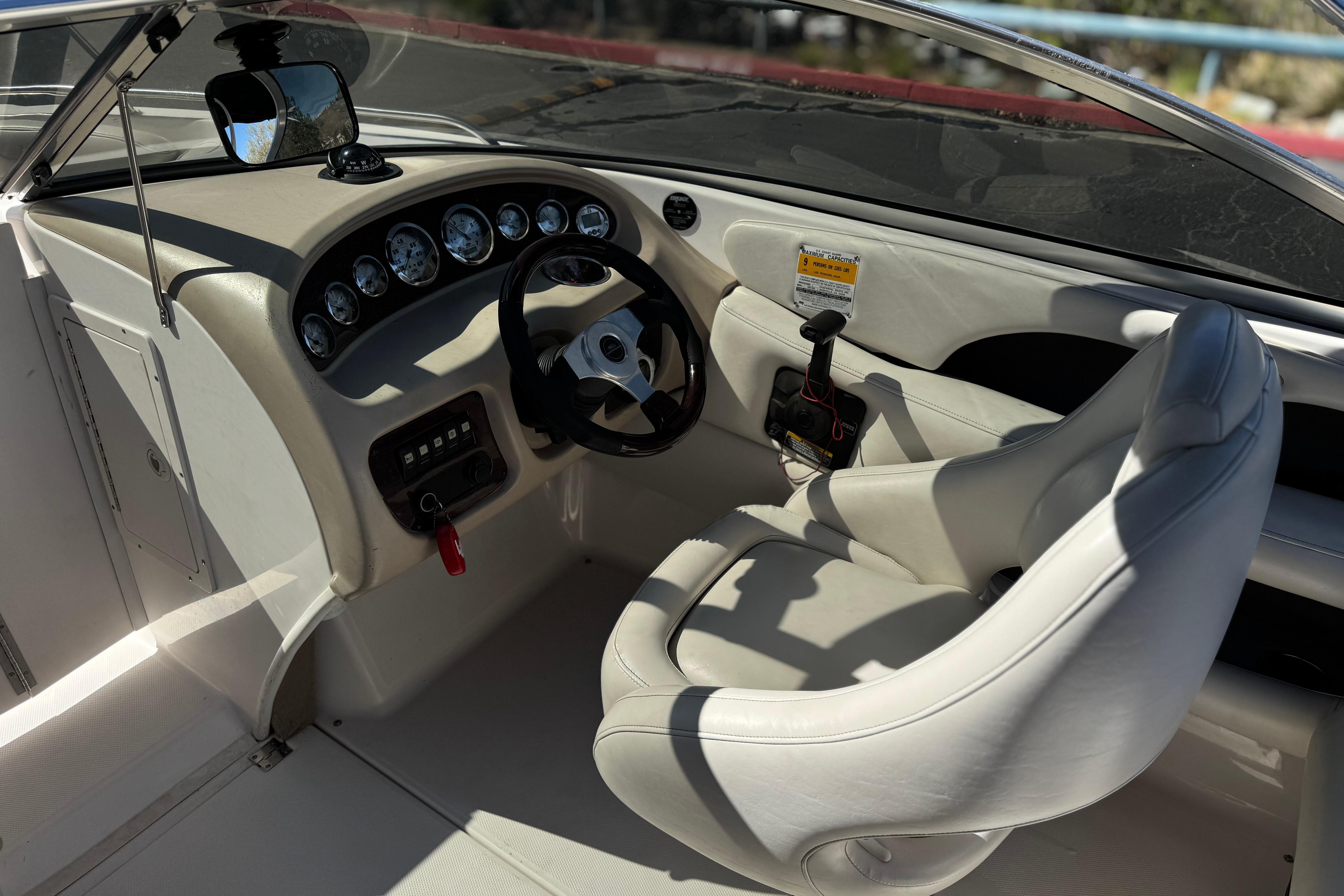 Interior of a 2002 Chaparral 186 SSi boat, featuring steering wheel and dashboard controls.
