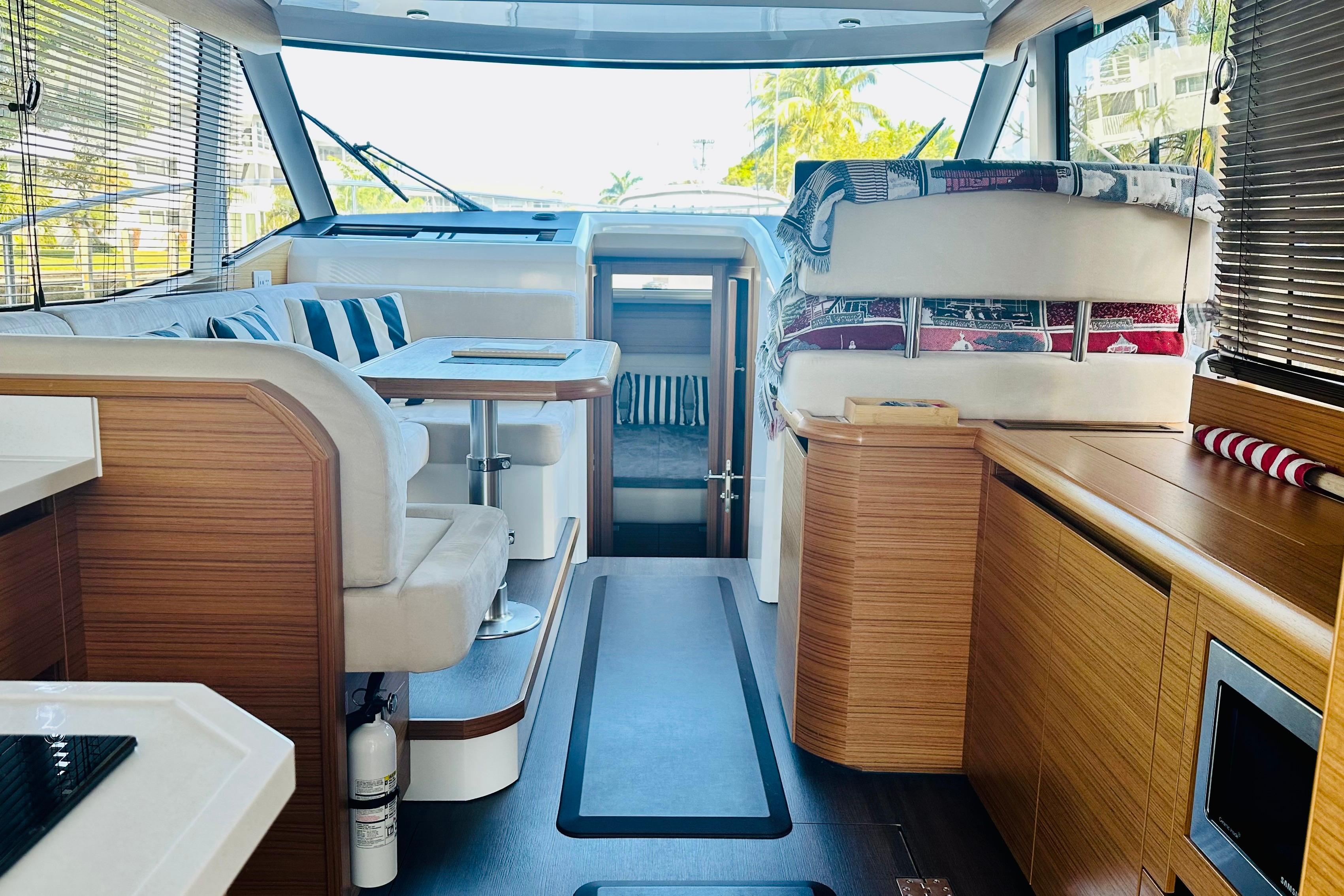 Interior of 2021 Greenline 39 Hybrid yacht, featuring modern seating and wooden finishes.