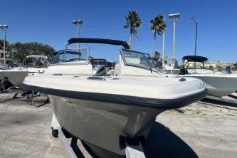 2022 Key West 239 DFS boat displayed outdoors with clear blue sky and palm trees.