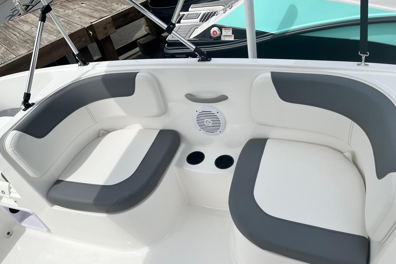 2026 Bayliner Element E16 boat interior with gray and white seating and cup holders.