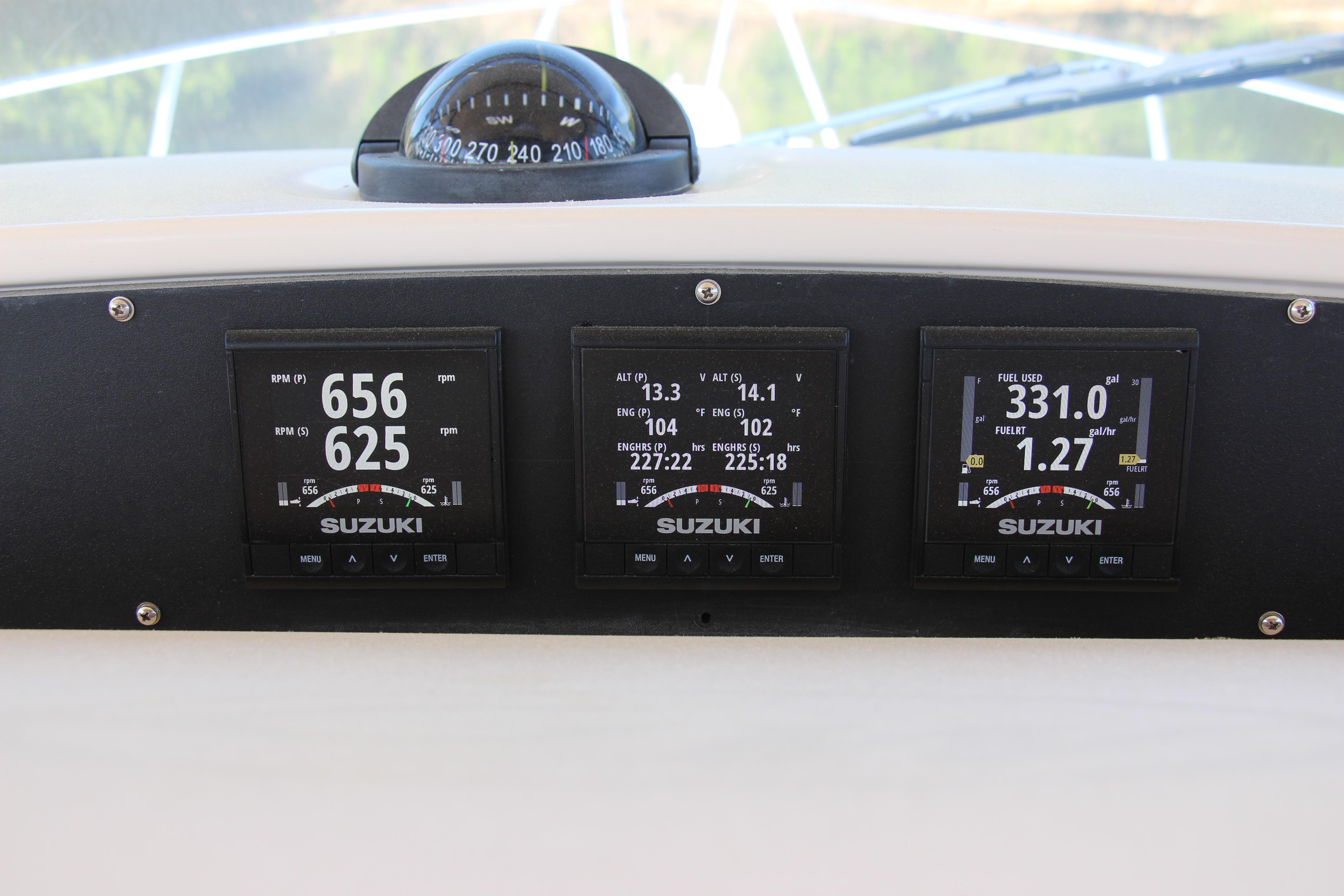 Dashboard of a 2005 Grady-White Express 330 with Suzuki engine displays.
