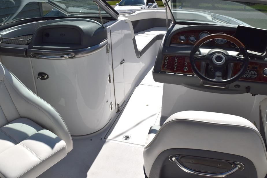 Interior of a 2006 Cobalt 240 boat, featuring sleek seating and a modern dashboard.