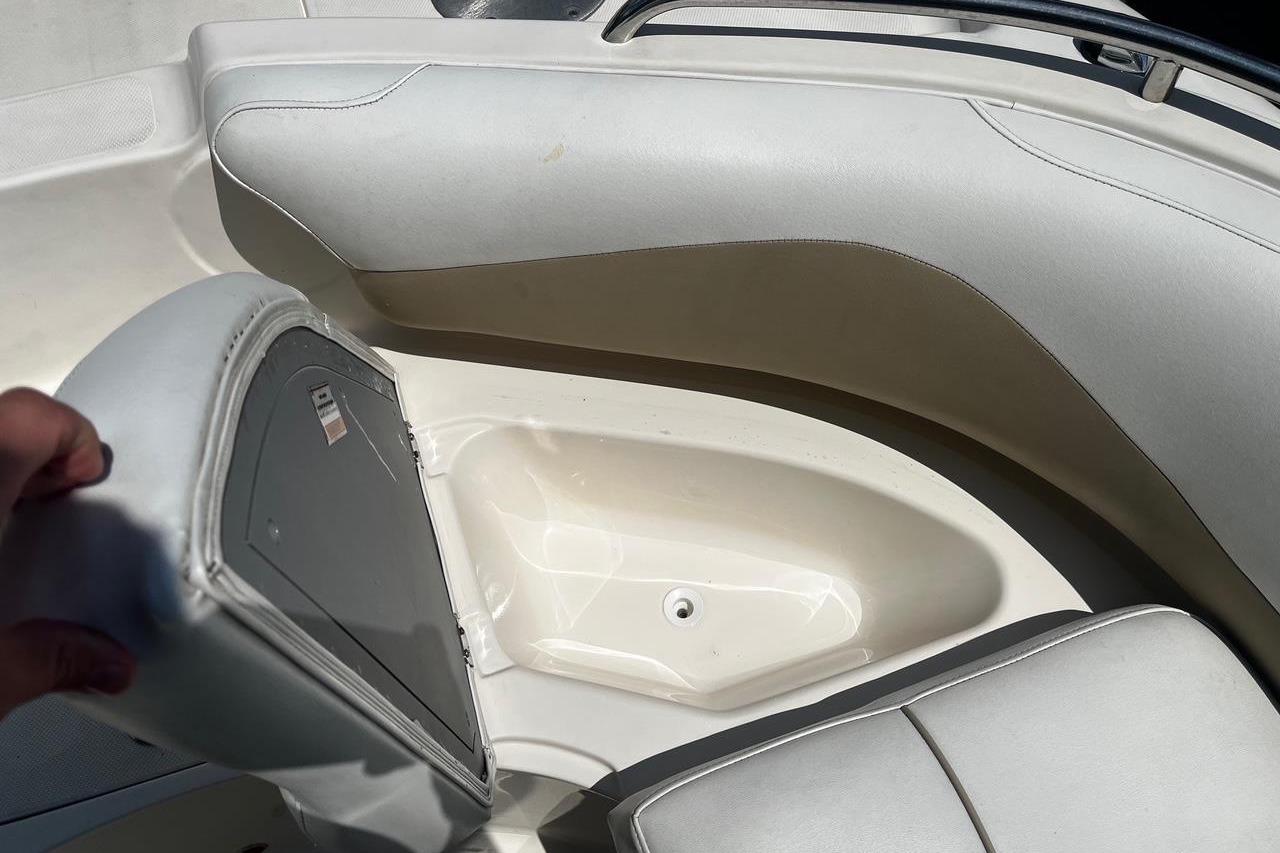Open storage compartment in 2008 Hurricane FD202 boat with cushioned seating.
