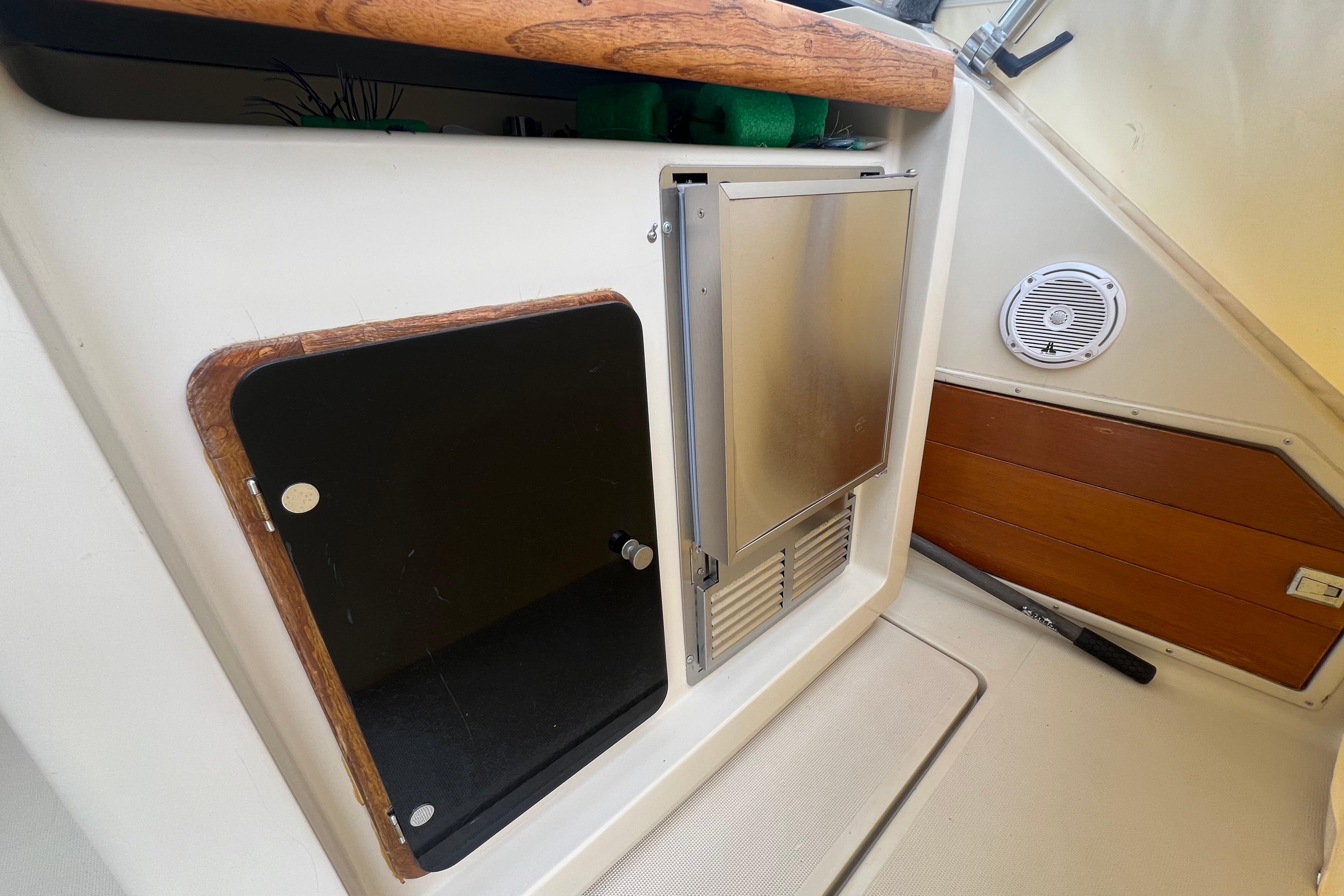 1985 Tiara 36 OPEN boat interior with storage compartments and speaker.