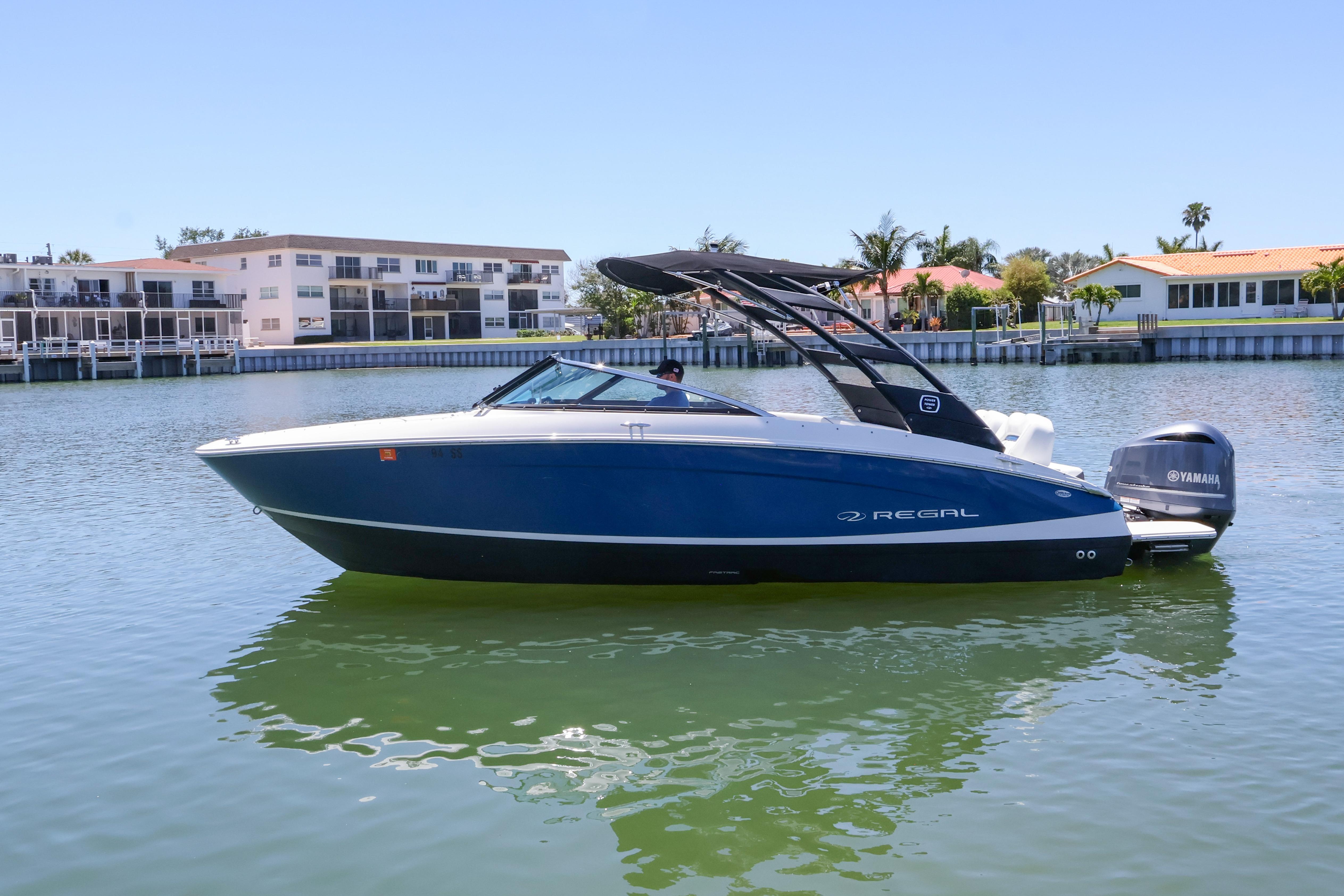 2020 Regal LX4 boat on calm water, featuring sleek design and Yamaha outboard motor.
