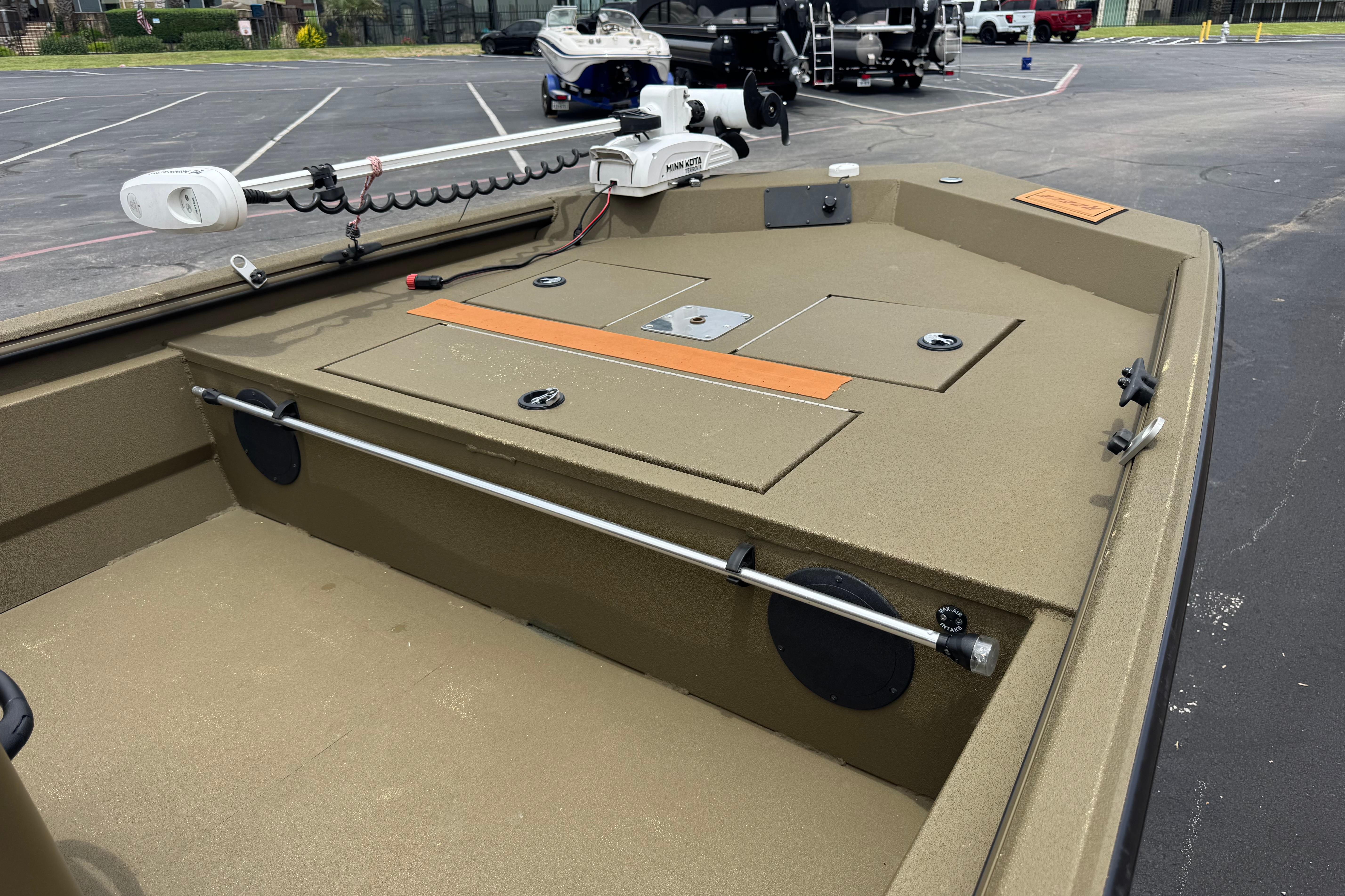 2023 Avid 18 Rogue CC boat deck with trolling motor in parking lot.