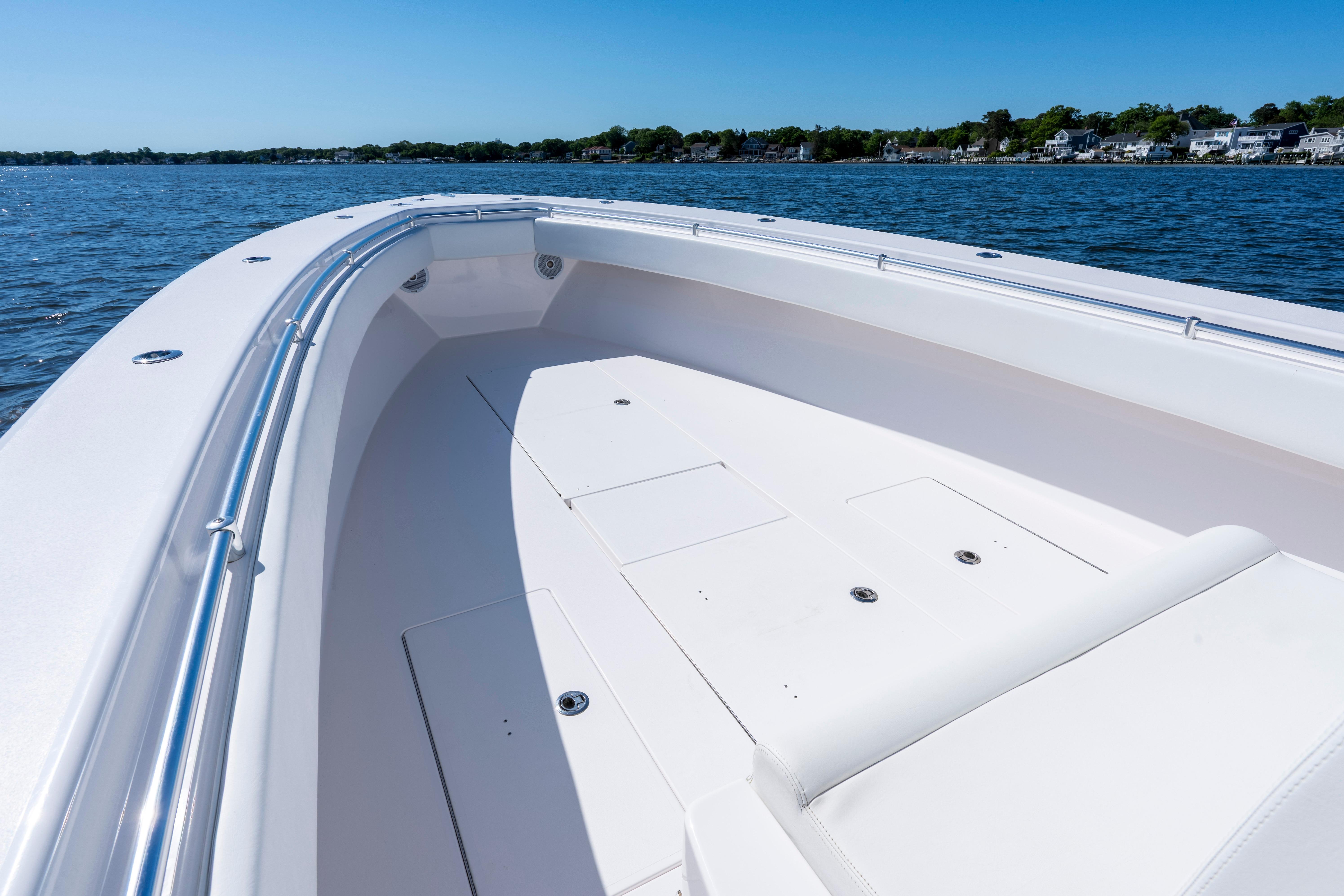 2015 Contender 39 ST boat deck on calm water, clear sky background.