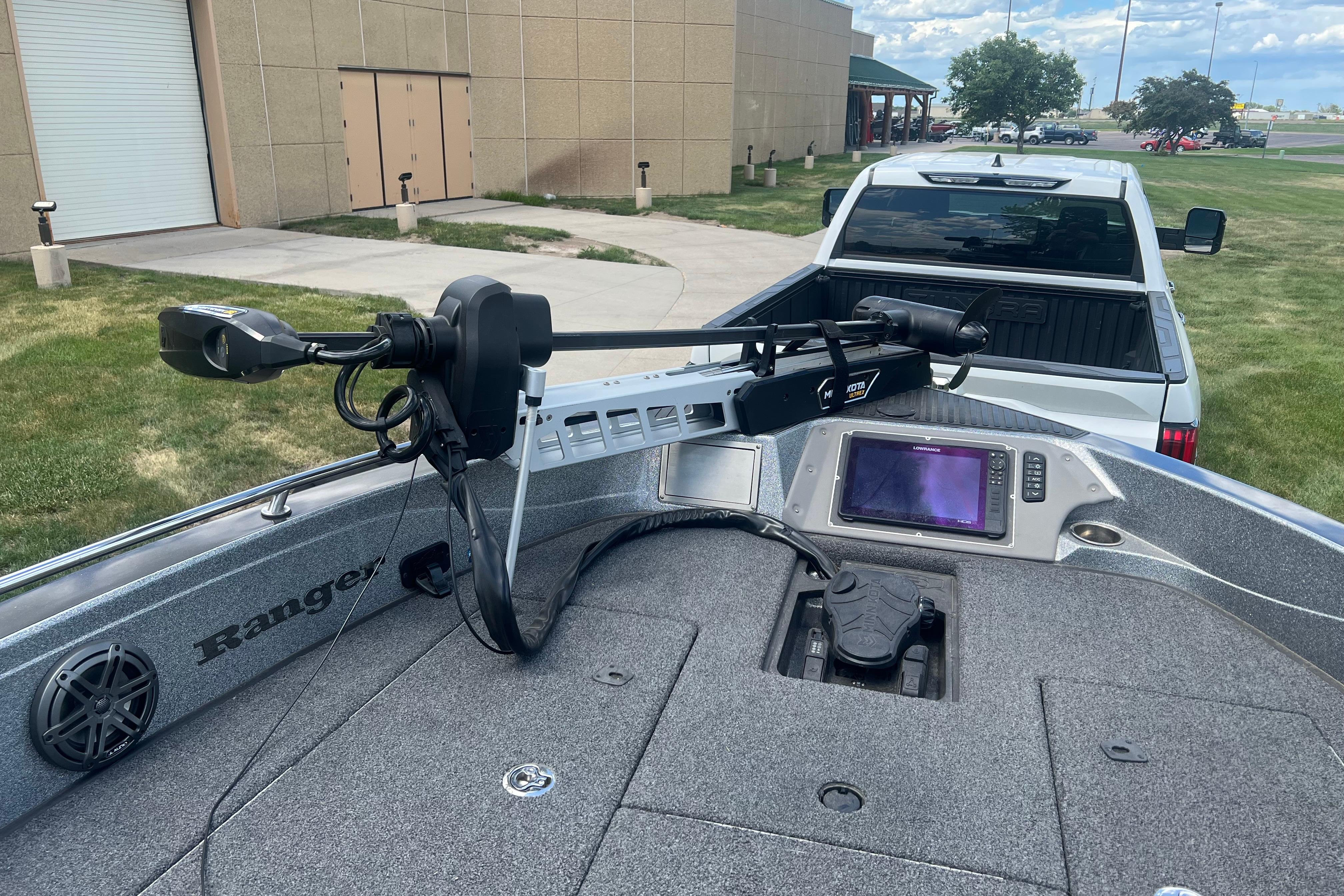 2023 Ranger 620FS Pro boat with advanced navigation system, parked near a white truck.