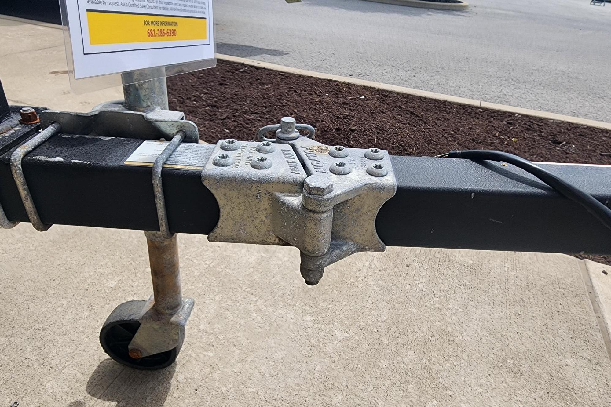 Trailer hitch of a 2022 GRIZZLEY 1654SPT on concrete pavement.